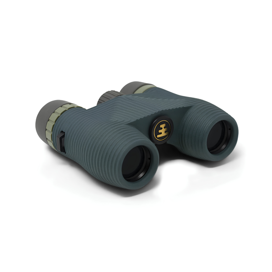Semi side view of Nocs Provisions Binocular Standard Issue 8X25 Cypress Green that has multi-coated lenses and premium BaK4 prisms, waterproof, fogproof and compact.