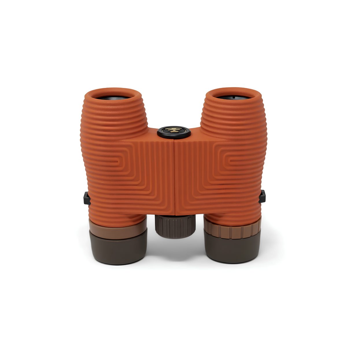 Nocs Provisions Binocular Standard Issue 8X25 Poppy Orange that has multi-coated lenses and premium BaK4 prisms, waterproof, fogproof and compact, showing the eyepieces down on the surface.
