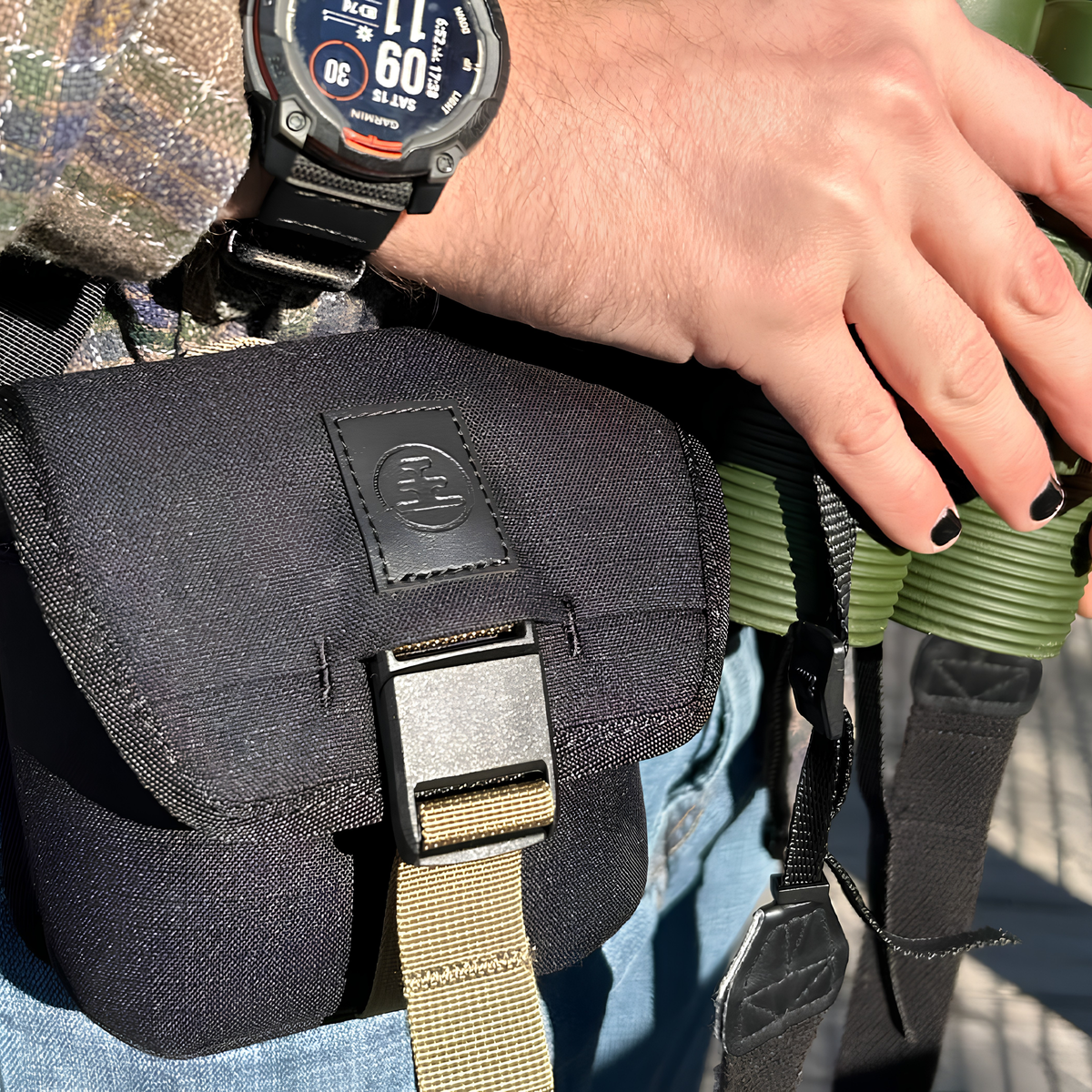 Nocs Provisions Binocular Standard Issue Pouch in charcoal black, recycled abrasion-resistant fabric with secure NocLoc closure, universal strap attachments and internal storage pocket, for a 25mm binocular, shown carried across the hips.