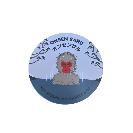 Cover of the Onsen Saru Hot Spring Soy Candle all natural soy wax, non-crackling wood wick, essential oils, tin measures 3 inches by 2.25