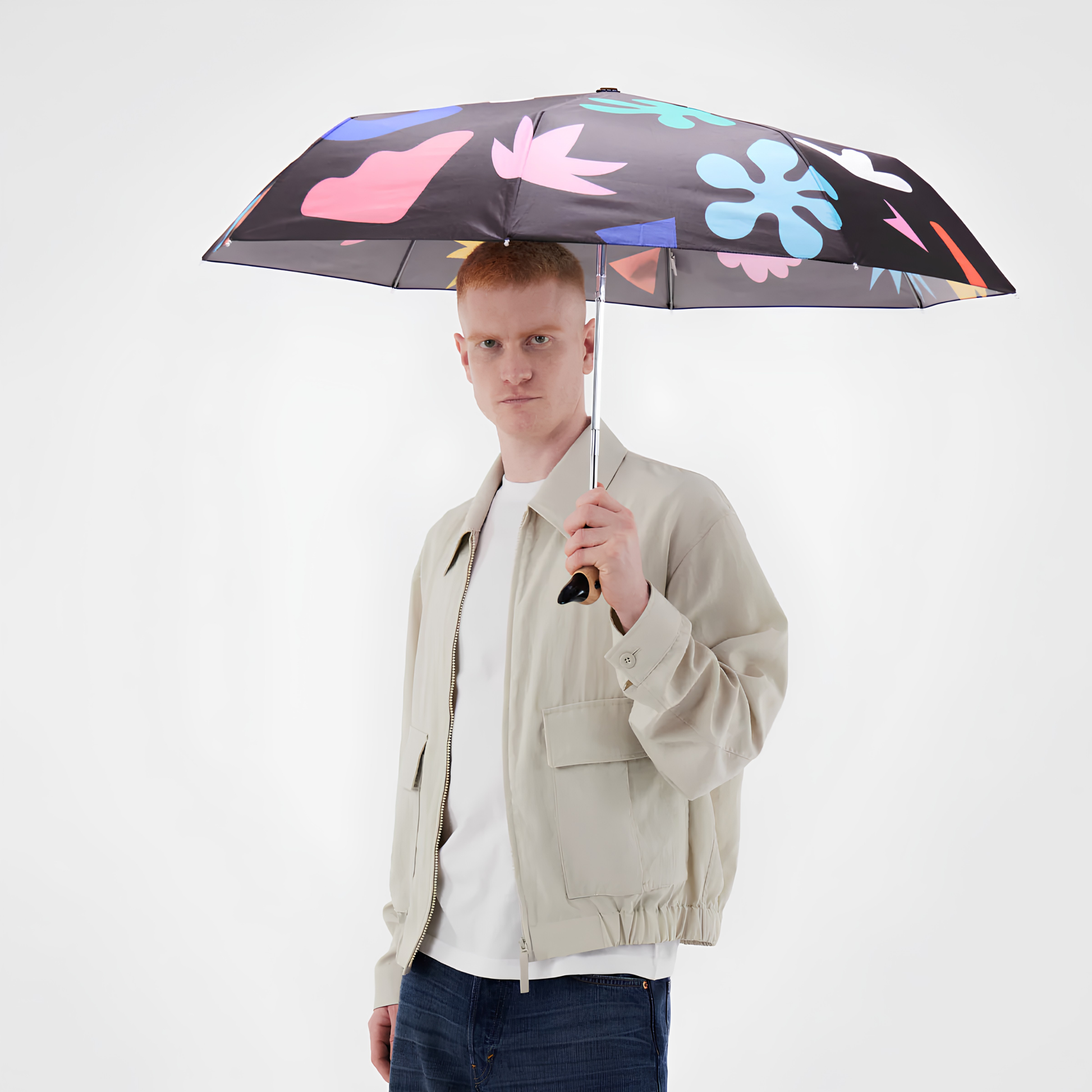 A man holding the open Original Duckhead Duck Umbrella Compact Palma, from sustainable materials.