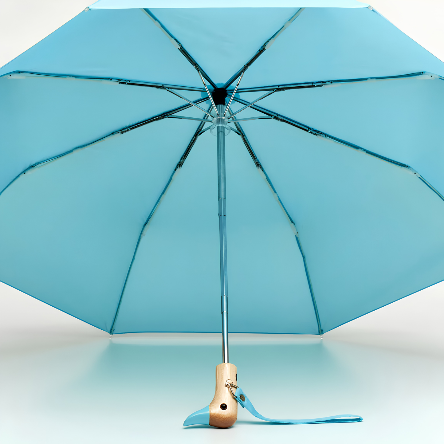 Open inside view of the Original Duckhead Duck Umbrella Compact Popsicle Blue or sky inspired, from sustainable materials.