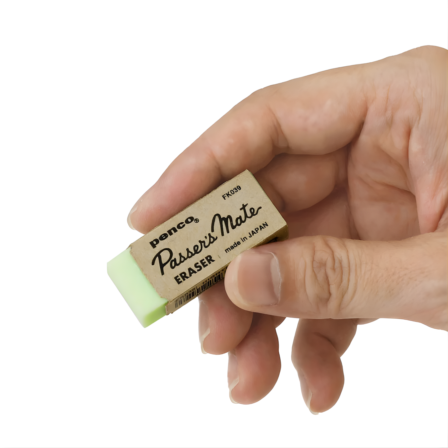 Upclose view of the Penco eraser green being held. Made of PVC, with retro design and removes mistakes with ease that measures 43mm W x12mm H x18mm D. Made in Japan.