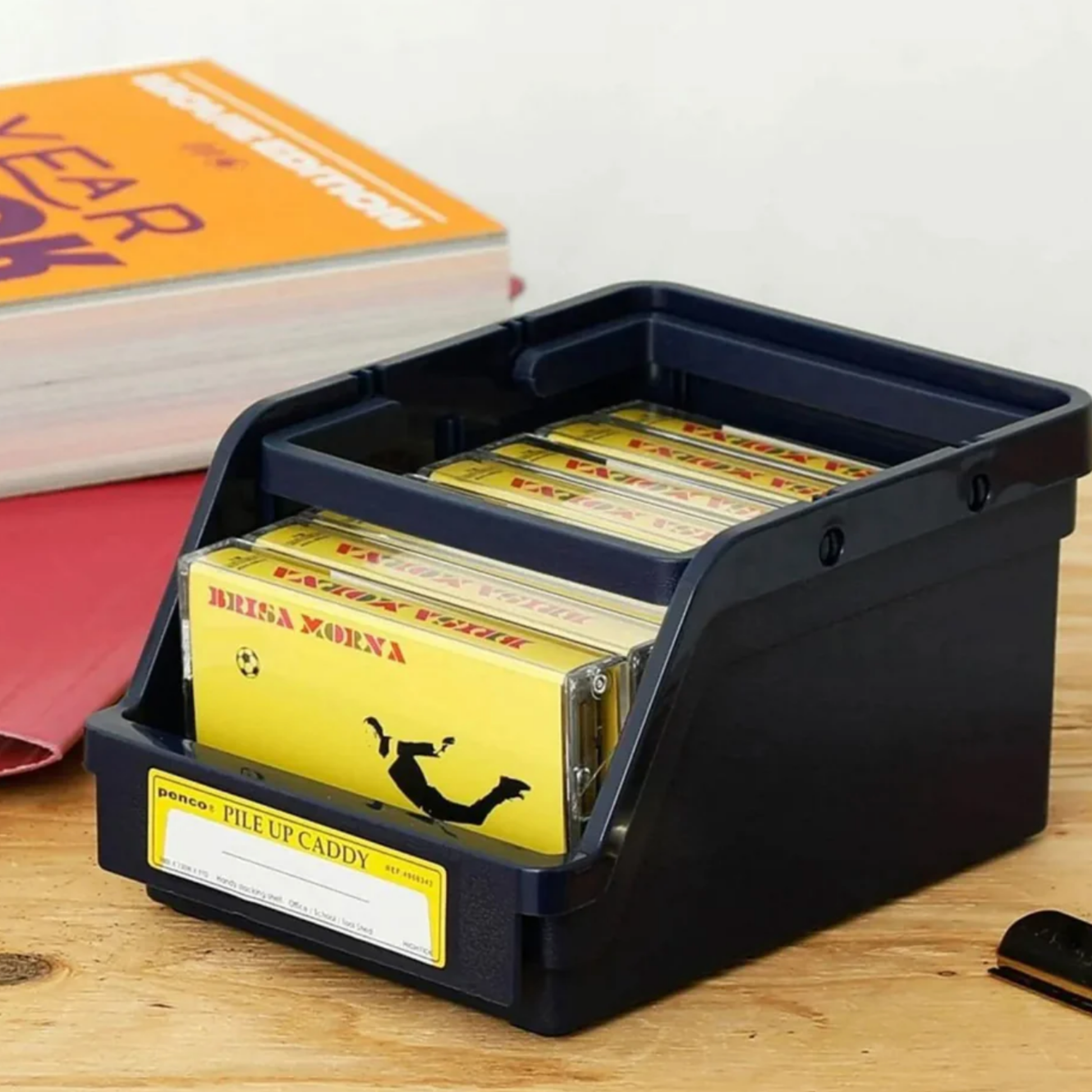 Penco pile up caddy front angled view with cassests inside on wooden desk