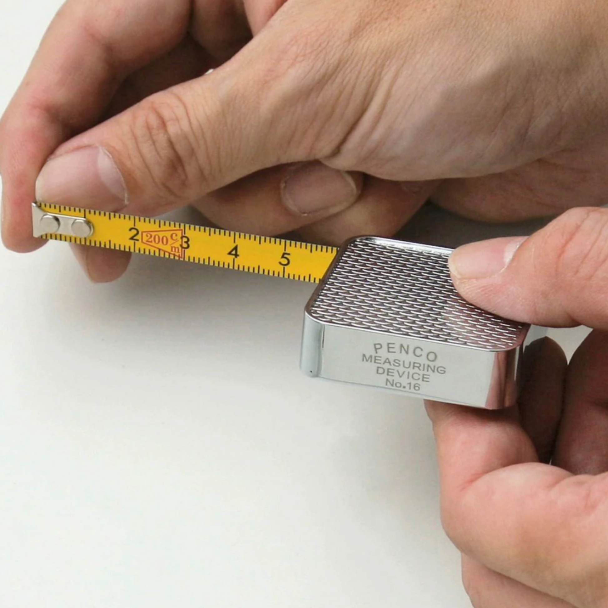 Man using Penco measuring tape top view 