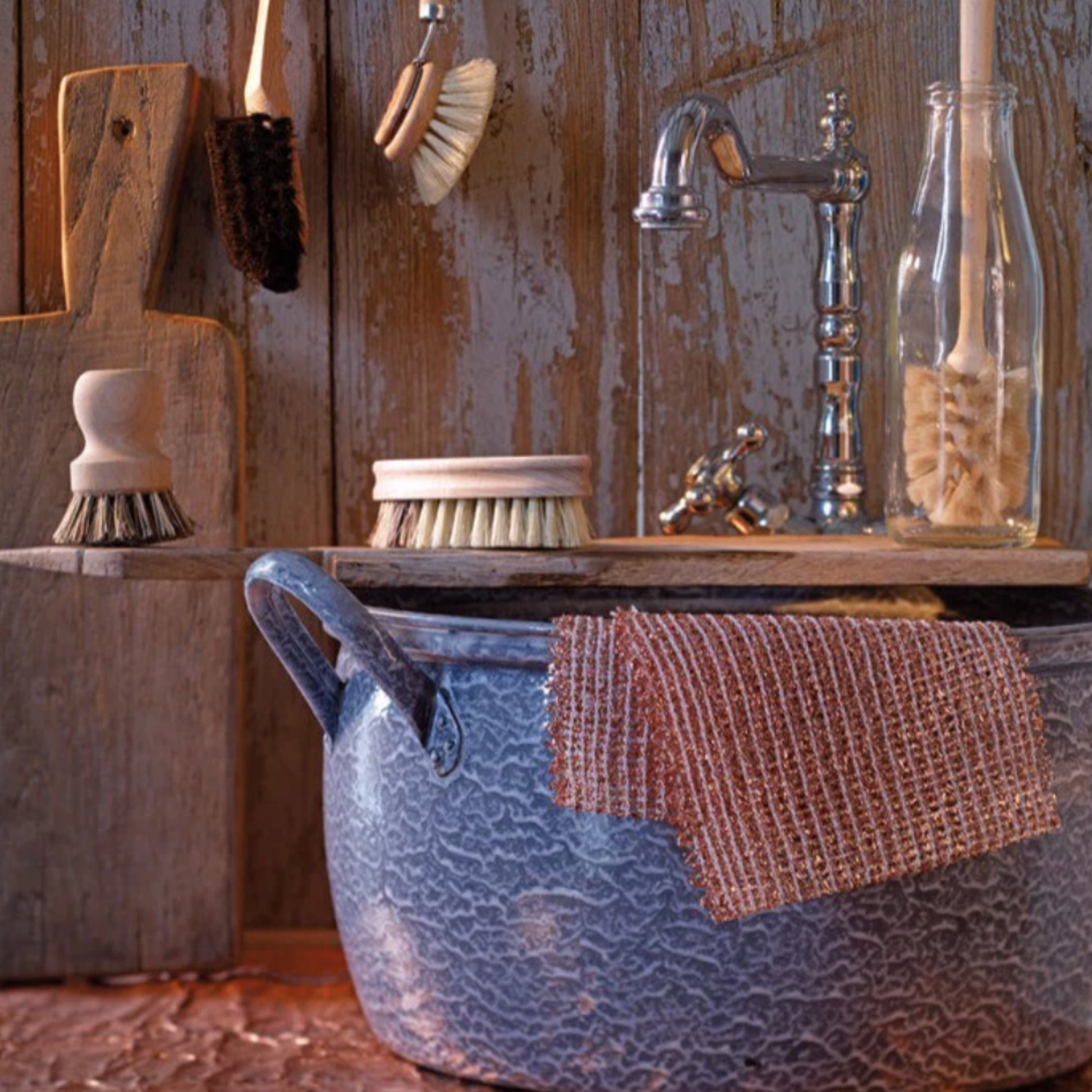 Redecker copper cloth 2 pack on display in kitchen drapped over pot with other redecker cleaning tools 