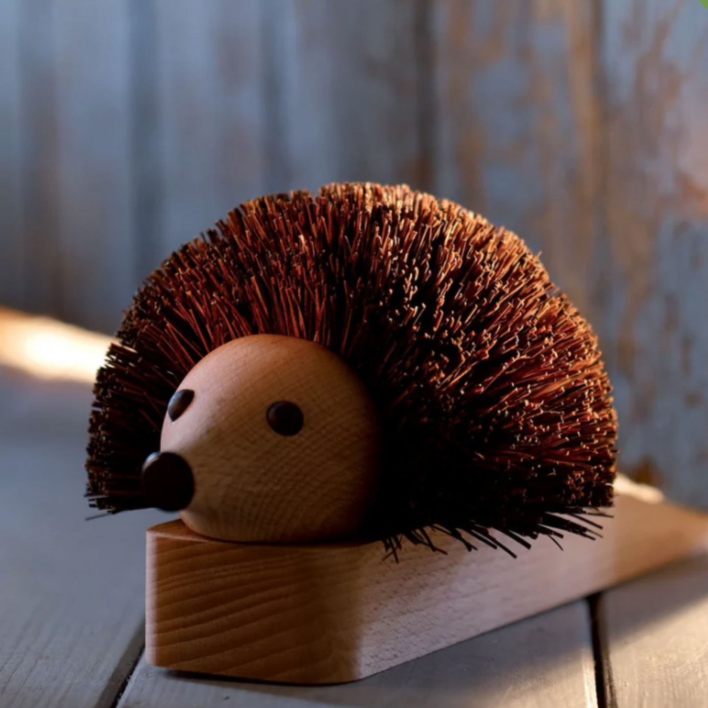 Redecker hedgehog door stop displayed holding open wooden door close up