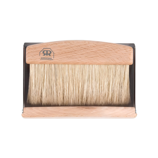 Front view of the Redecker Table Sweeping Set light brown made from stainless steel and soft natural bristles which includes a sleek tray and matching hand brush detachable by a magnet.