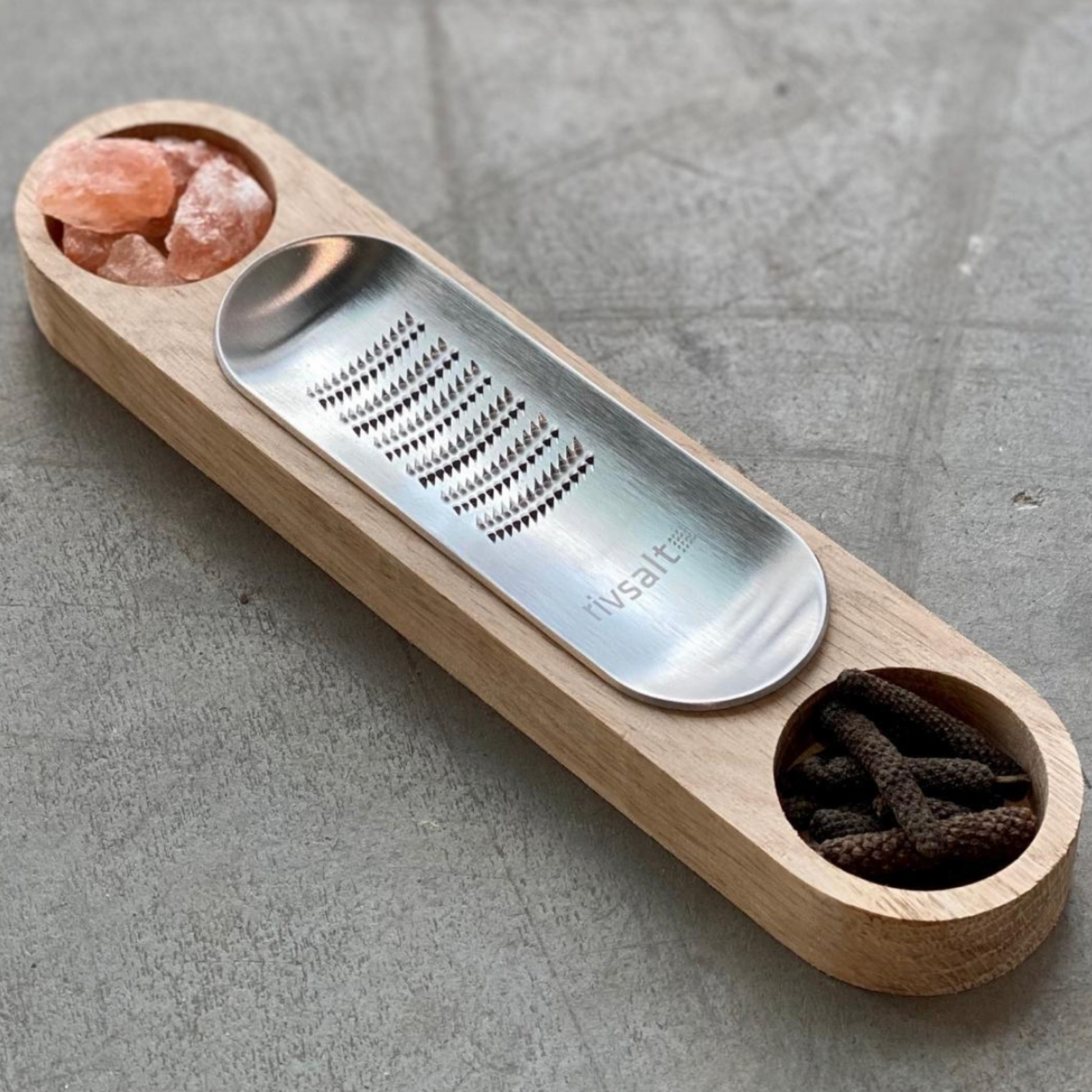 Rivsalt Dining Table Essentials Salt & Pepper displayed on concrete table