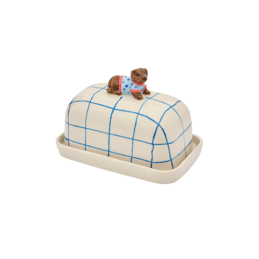 Top left facing Robert Gordon Butter Dish Dachshund made from high fired porcelain with blue brushwork lines and a hand-painted dog perched on top.