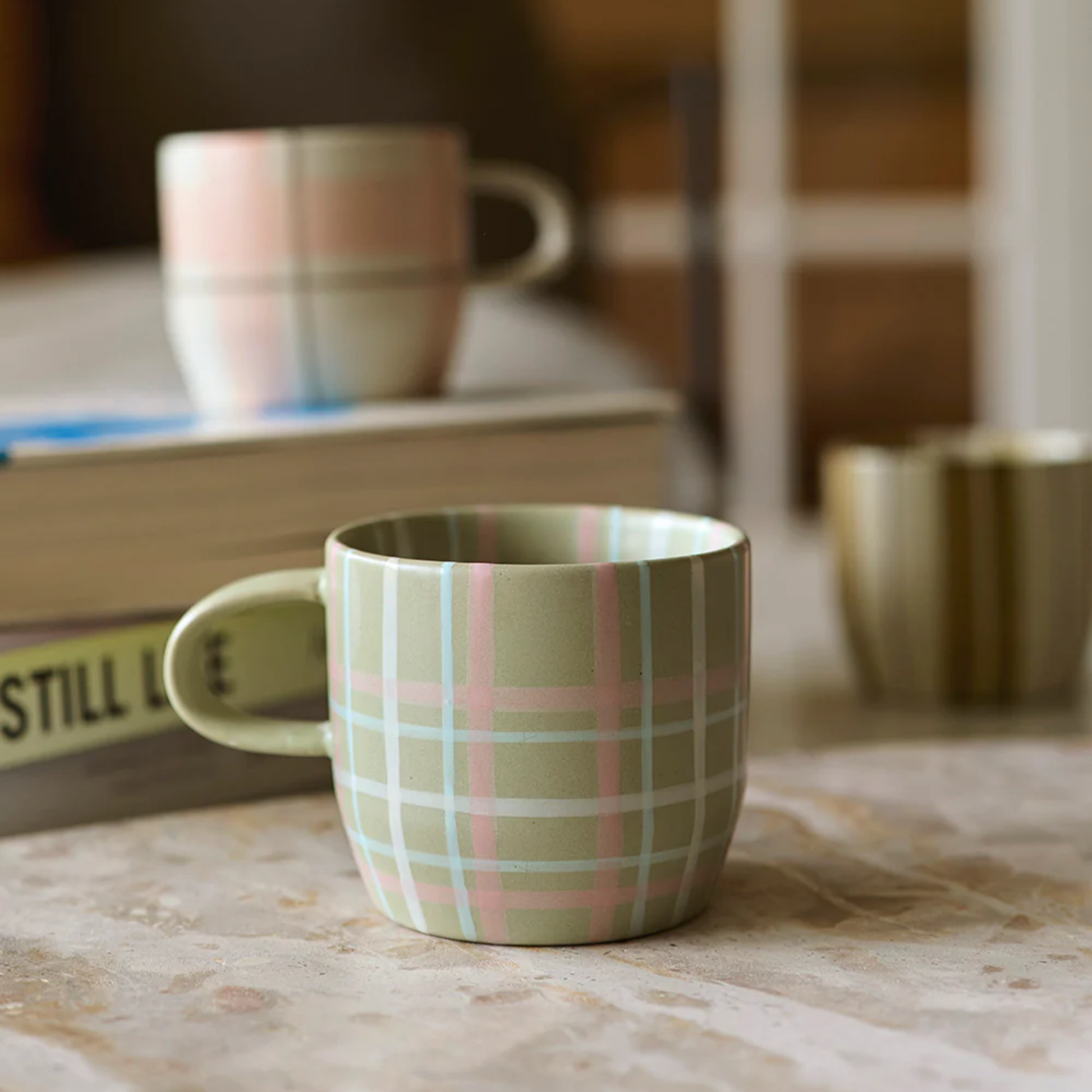 Robert Gordon cats pyjamas mug sage and blush on display on marble table with robert gordon muhgs in background