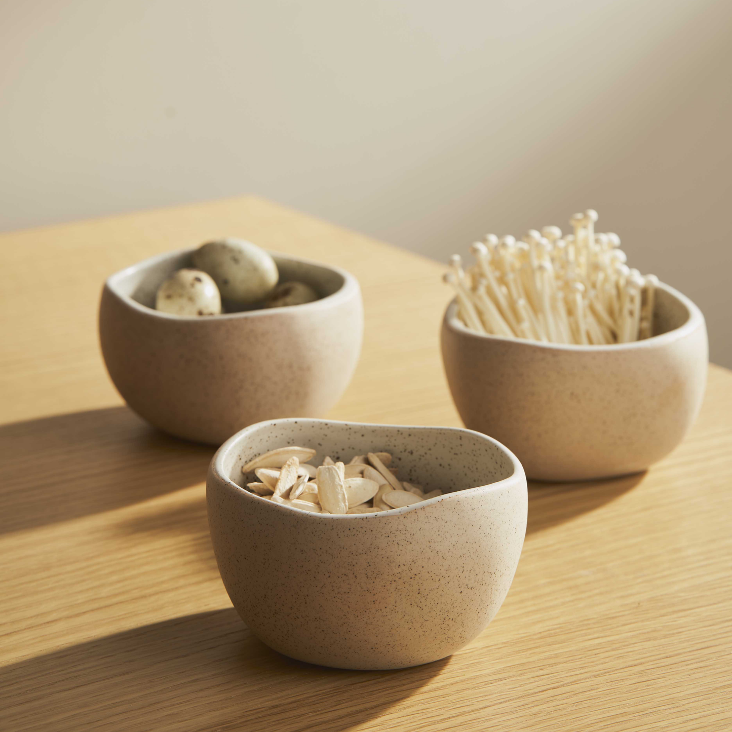 Three Robert Gordon garden to table granite bowls on wooden table