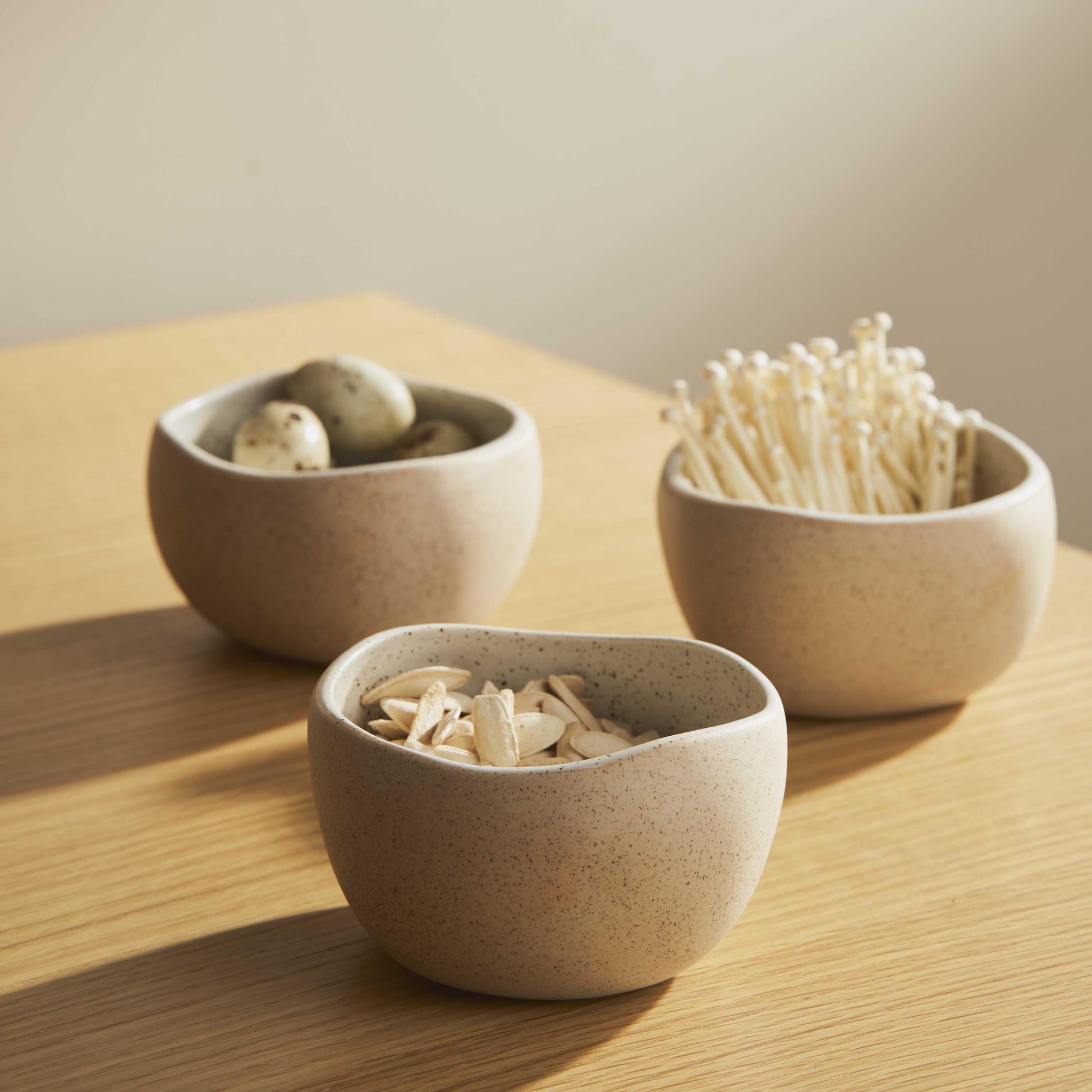 Three Robert Gordon garden to table granite bowls on wooden table