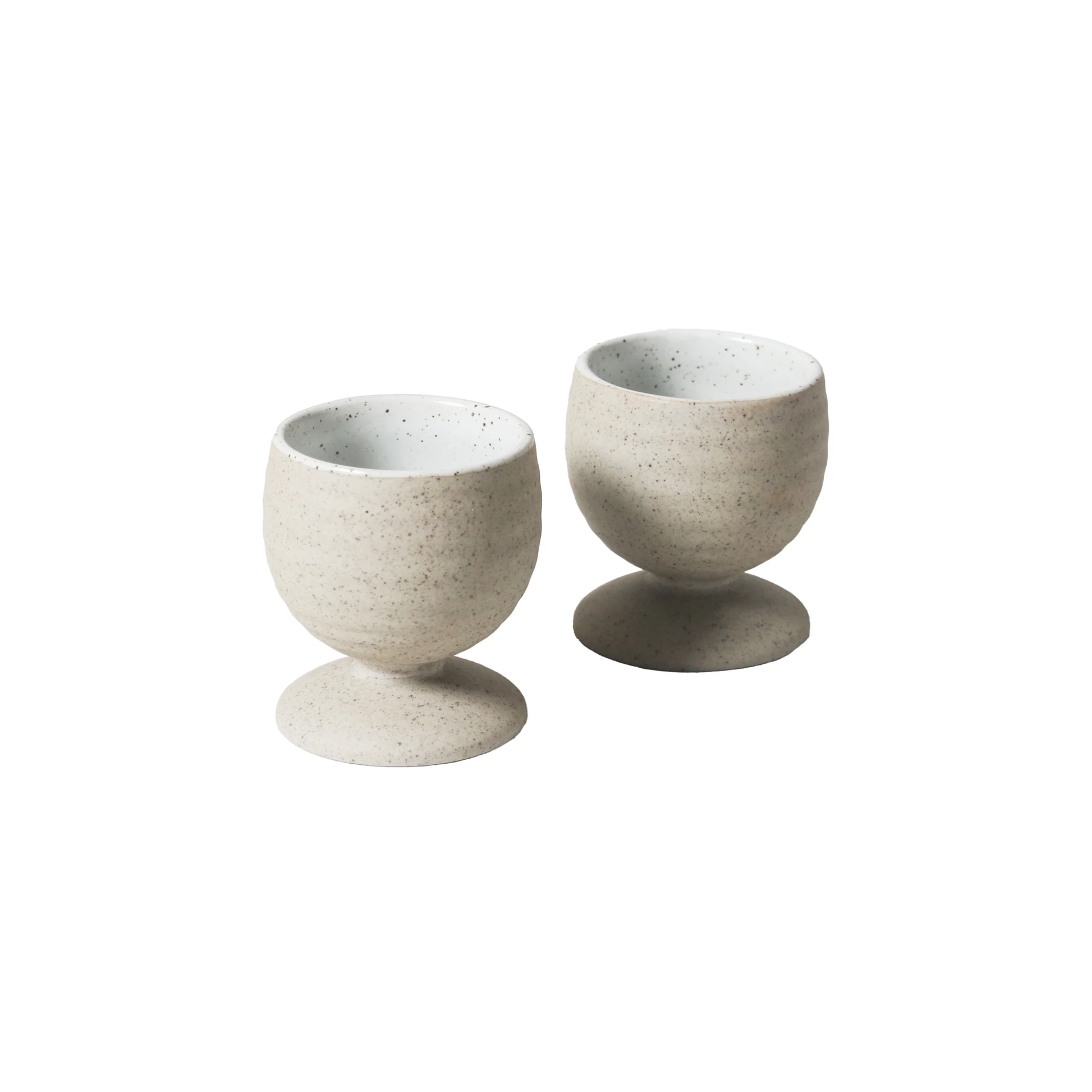 Front view of two Robert Gordon Garden To Table Egg Cups (set of 2) 5.3cm | 6cm Off-white Earthly clay body with light organic glaze and dark speckles, hand crafted made from stoneware, microwave and dishwasher safe, designed in Australia, made in China.