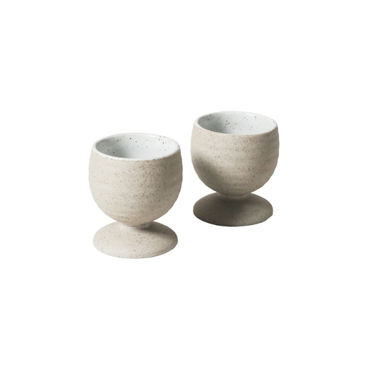 Front view of two Robert Gordon Garden To Table Egg Cups (set of 2) 5.3cm | 6cm Off-white Earthly clay body with light organic glaze and dark speckles, hand crafted made from stoneware, microwave and dishwasher safe, designed in Australia, made in China.
