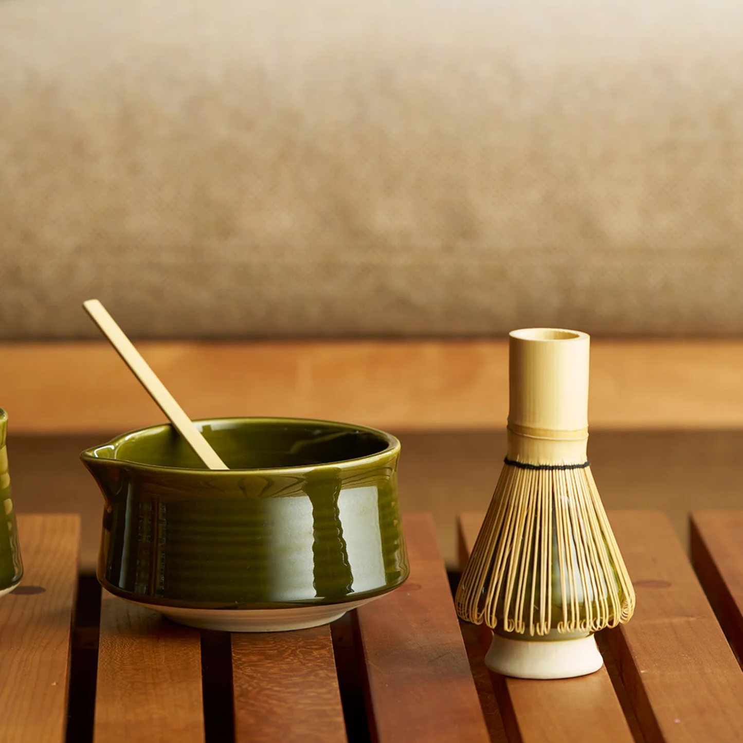 Displayed on the table, the Robert Gordon Matcha 4 Piece Set Matcha for traditional ceremonial matcha which are the ceramic bowl, whisk holder and bamboo whisk and scoop.