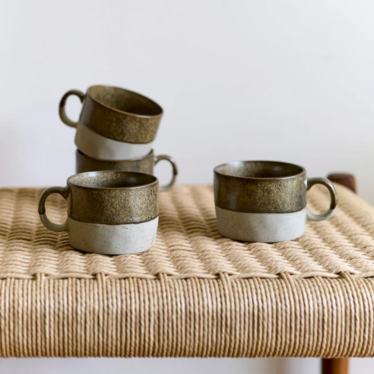 Robert Gordon mineral mugs copper set of 4 on display on woven chair