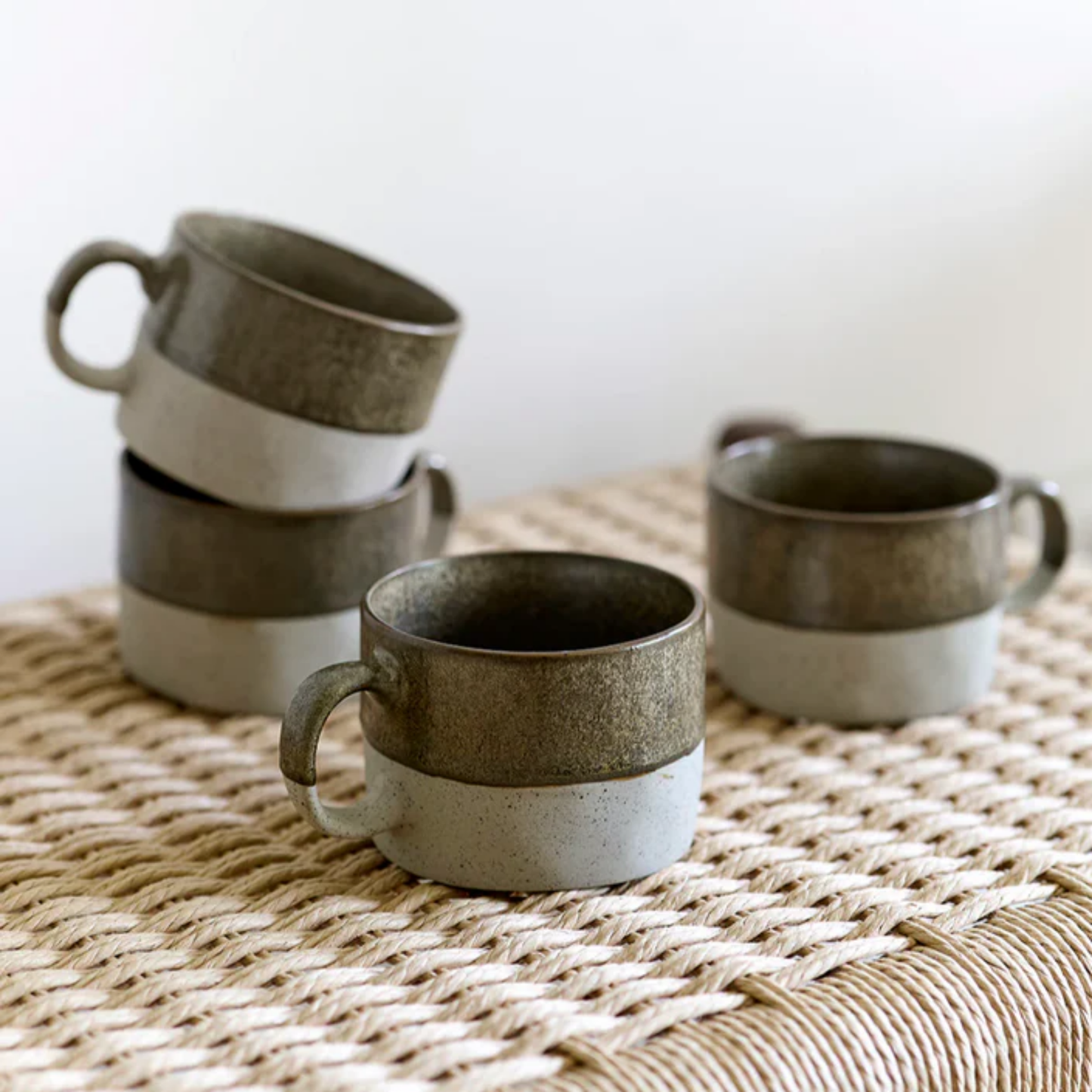 Robert Gordon mineral mugs copper set of 4 on display on woven chair close up