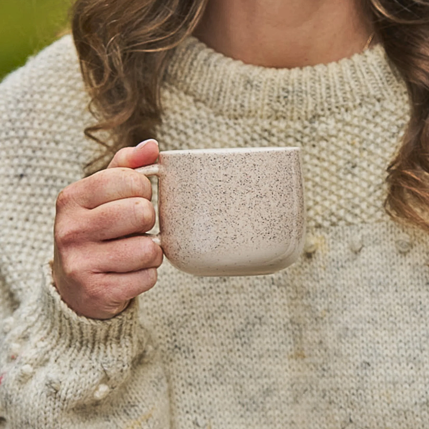 Another image of a woman holding the Robert Gordon My Mug (set of 4) Celestial 350ml capacity Off-white featuring delicate speckling giving charm and character, made from durable stoneware, microwave and dishwasher safe, designed in Australia, made in China.