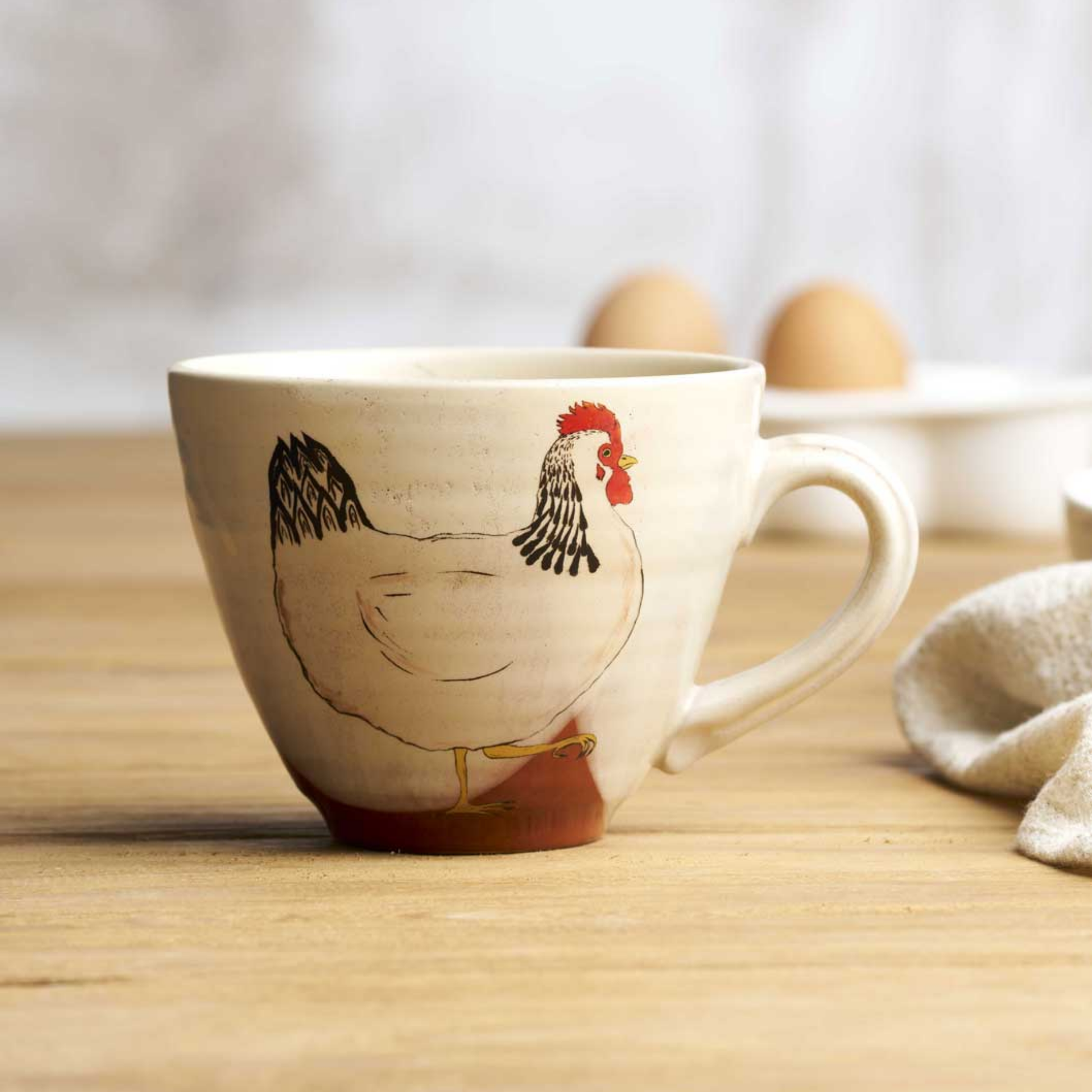 Robert Gordon oversized chicken mug baby side view on wooden table with eggs in background