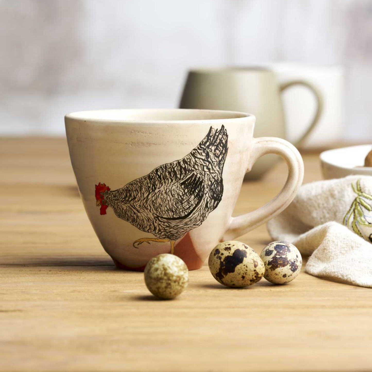 Robert Gordon oversized chicken mug mable side view on wooden table with eggs infront of mug