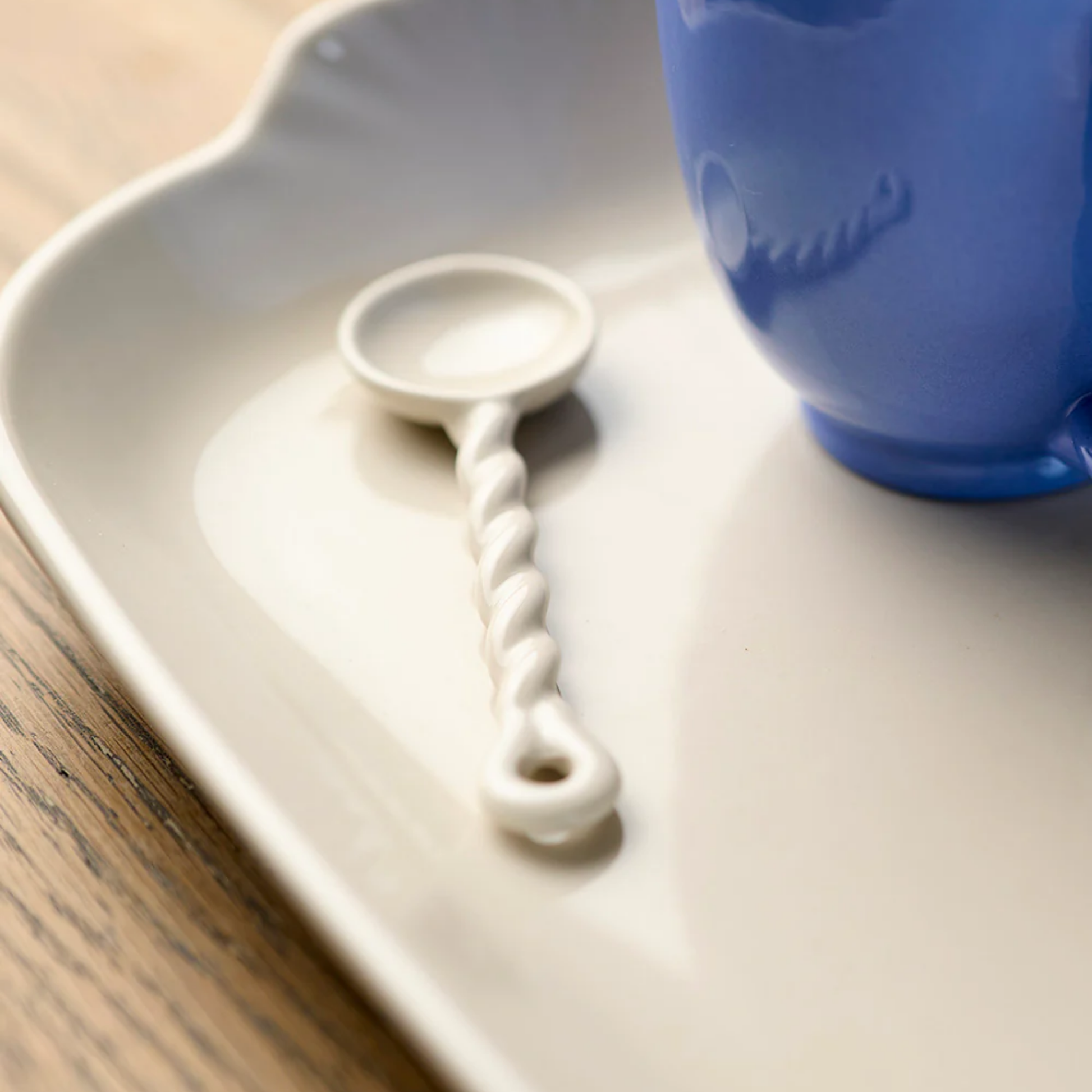 Robert Gordon twisted spoon on display on ceramic tray on wooden table