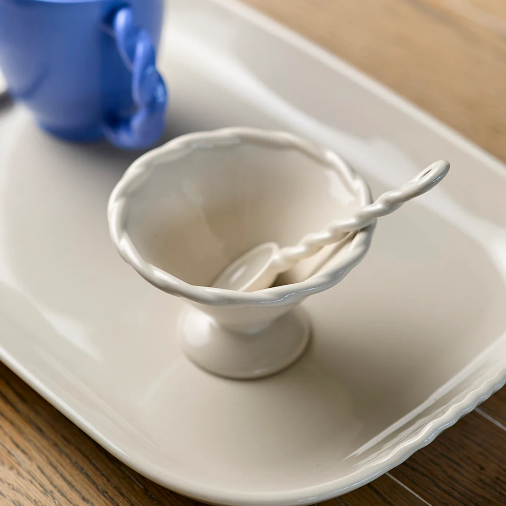 Robert Gordon twisted spoon on display in condiment bowl on ceramic tray on wooden table