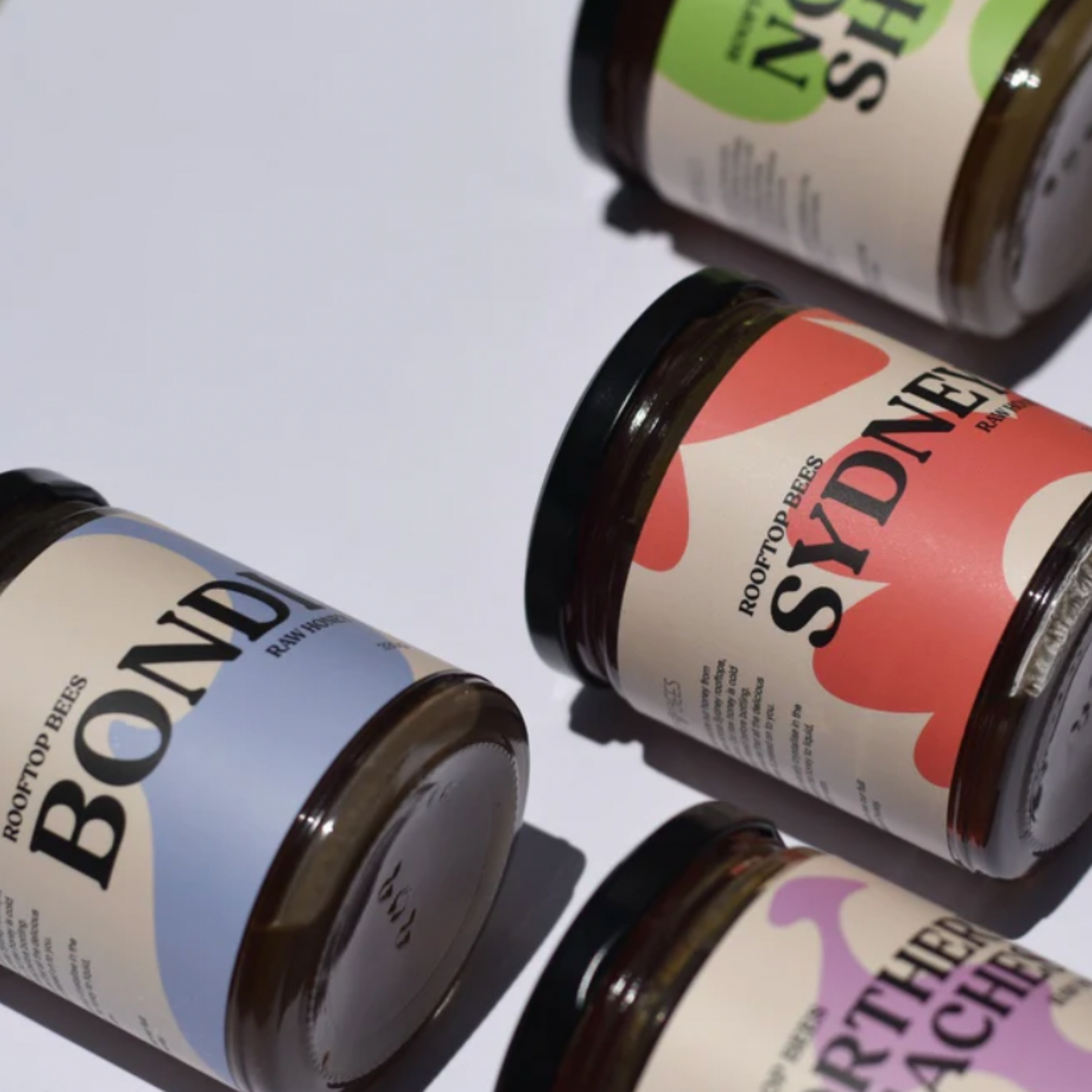 Assorted jars of Rooftop Bees raw honey including Bondi raw honey