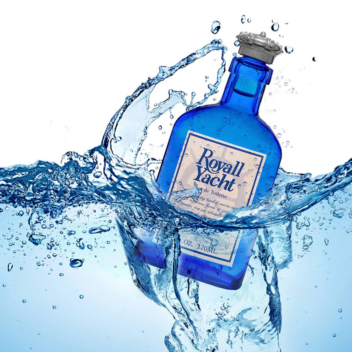 Royall Lyme Royall Yacht blue handmade glass bottle with pewter-colored crown cap, white label with blue text, 120 mL size; features luxurious packaging including fine parchment wrap and a crown wax seal, on the blue water.