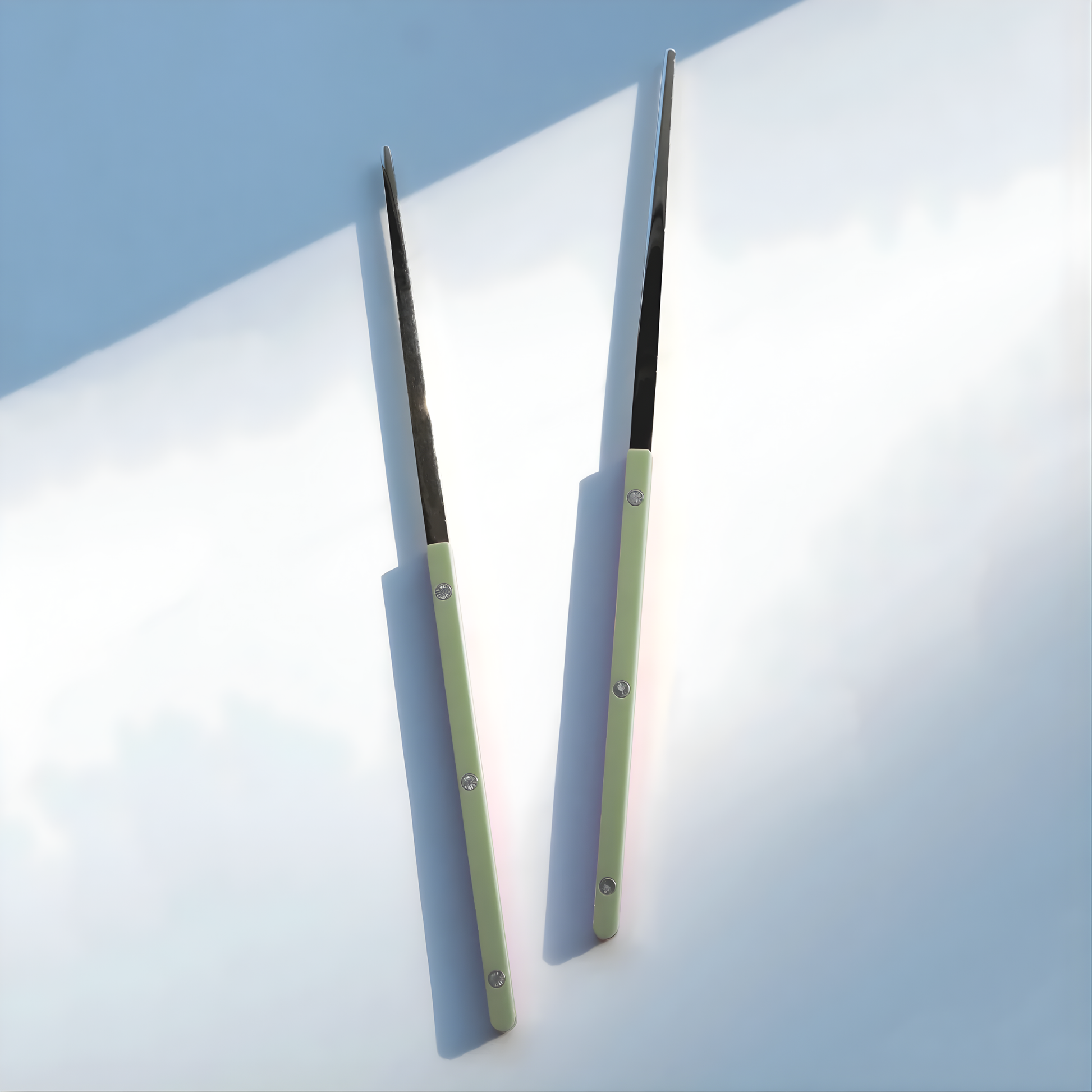 On a surface, the Sabre Bistrot Cutlery Chopsticks 23cm (pair) Asparagus, which is made from Inox 18/10 - Manche nylon, not dishwasher safe and not suitable in microwave oven, ergonomic design for comfortable grip, ideal for enjoying dishes such as sushi or noodles.