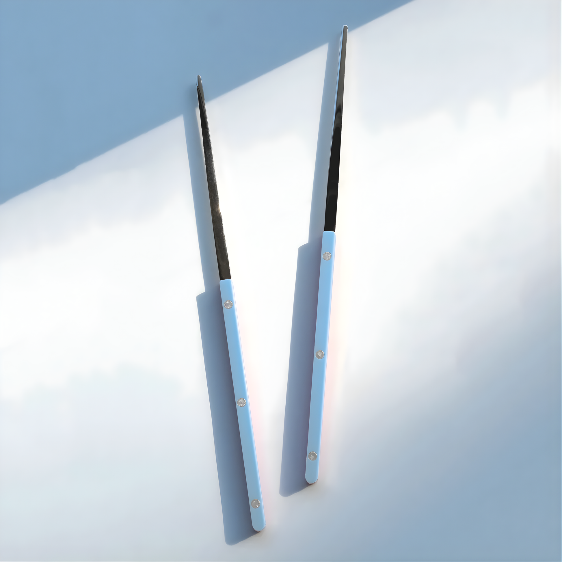 On a surface, the Sabre Bistrot Cutlery Chopsticks 23cm (pair) Pastel Blue, which is made from Inox 18/10 - Manche nylon, not dishwasher safe and not suitable in microwave oven, ergonomic design for comfortable grip, ideal for enjoying dishes such as sushi or noodles.