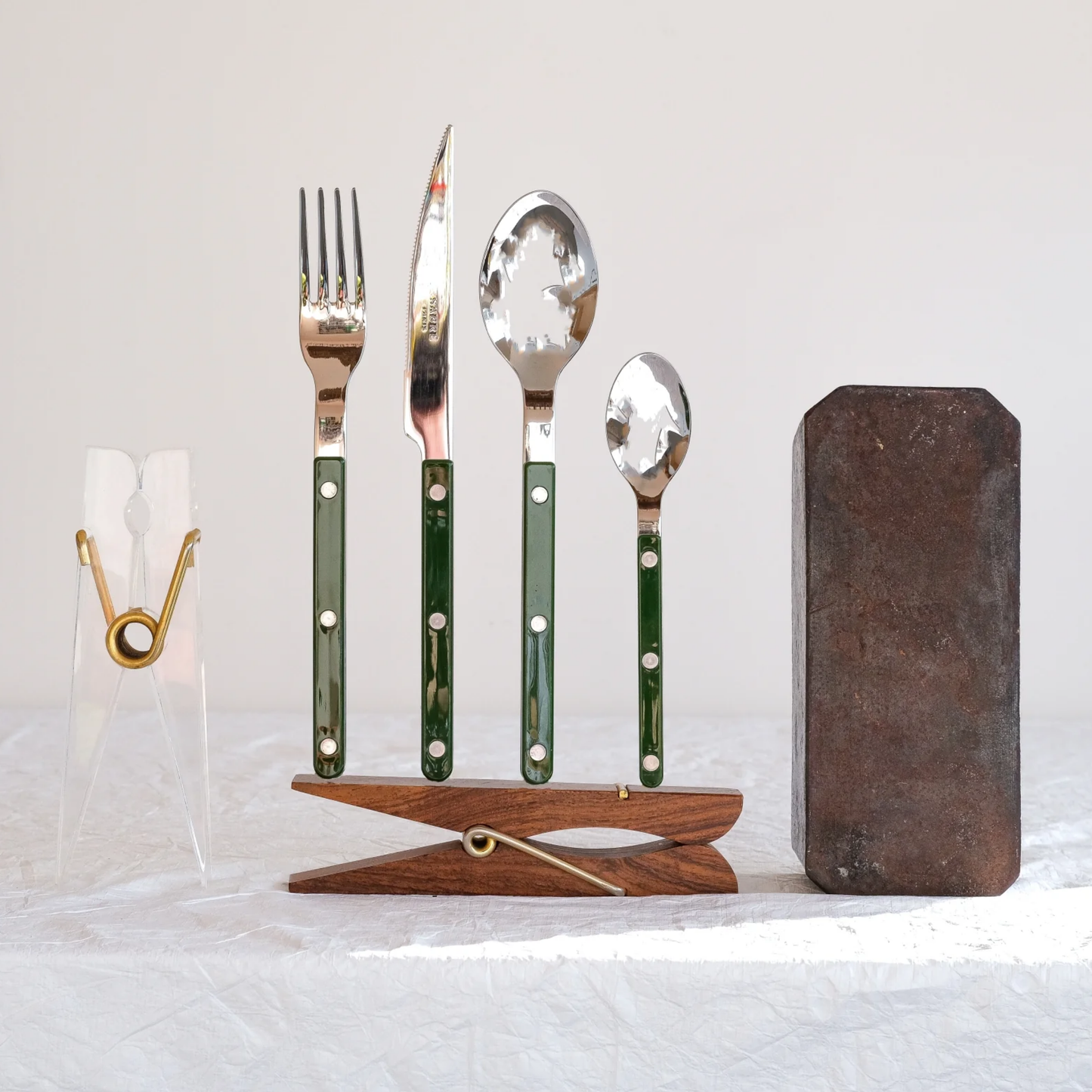 Fork, knife, spoon and teaspoon standing on a wooden clip, from Sabre Bistrot Cutlery Dark Green 24 Piece Set