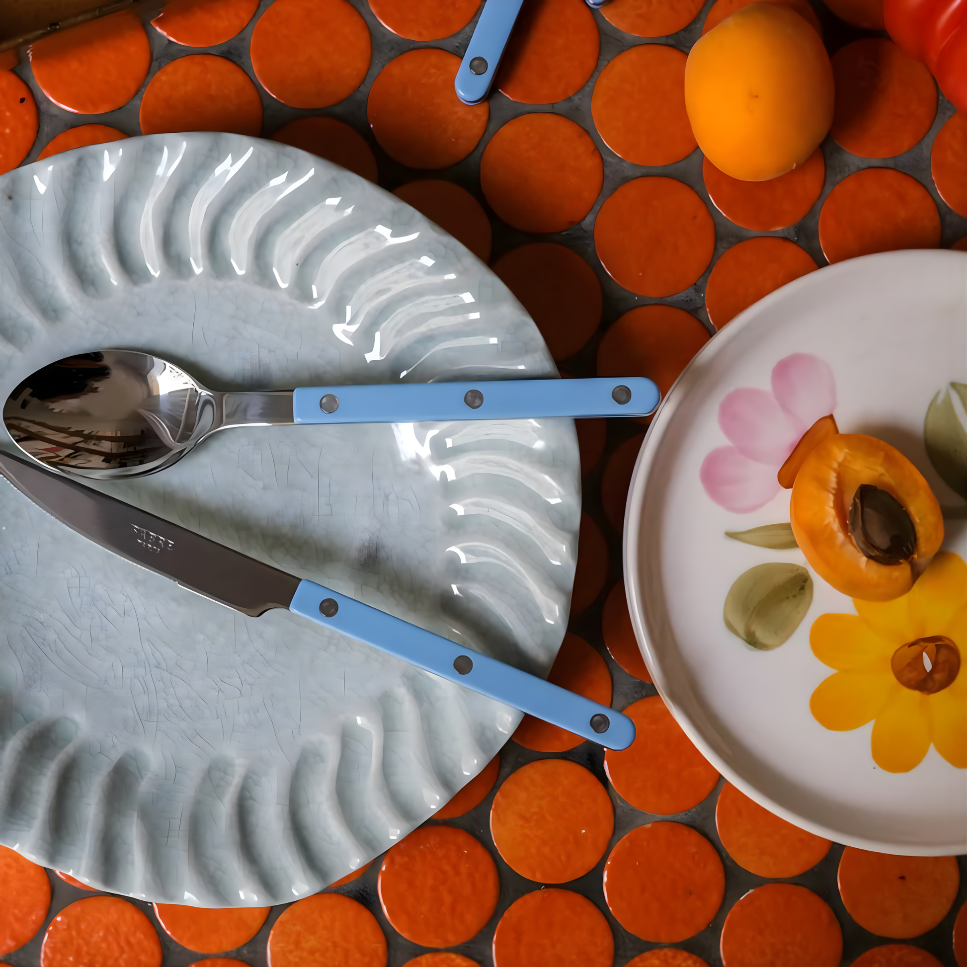 Knife and spoon on a plate from Sabre Bistrot Cutlery Pastel Blue 24 Piece Set