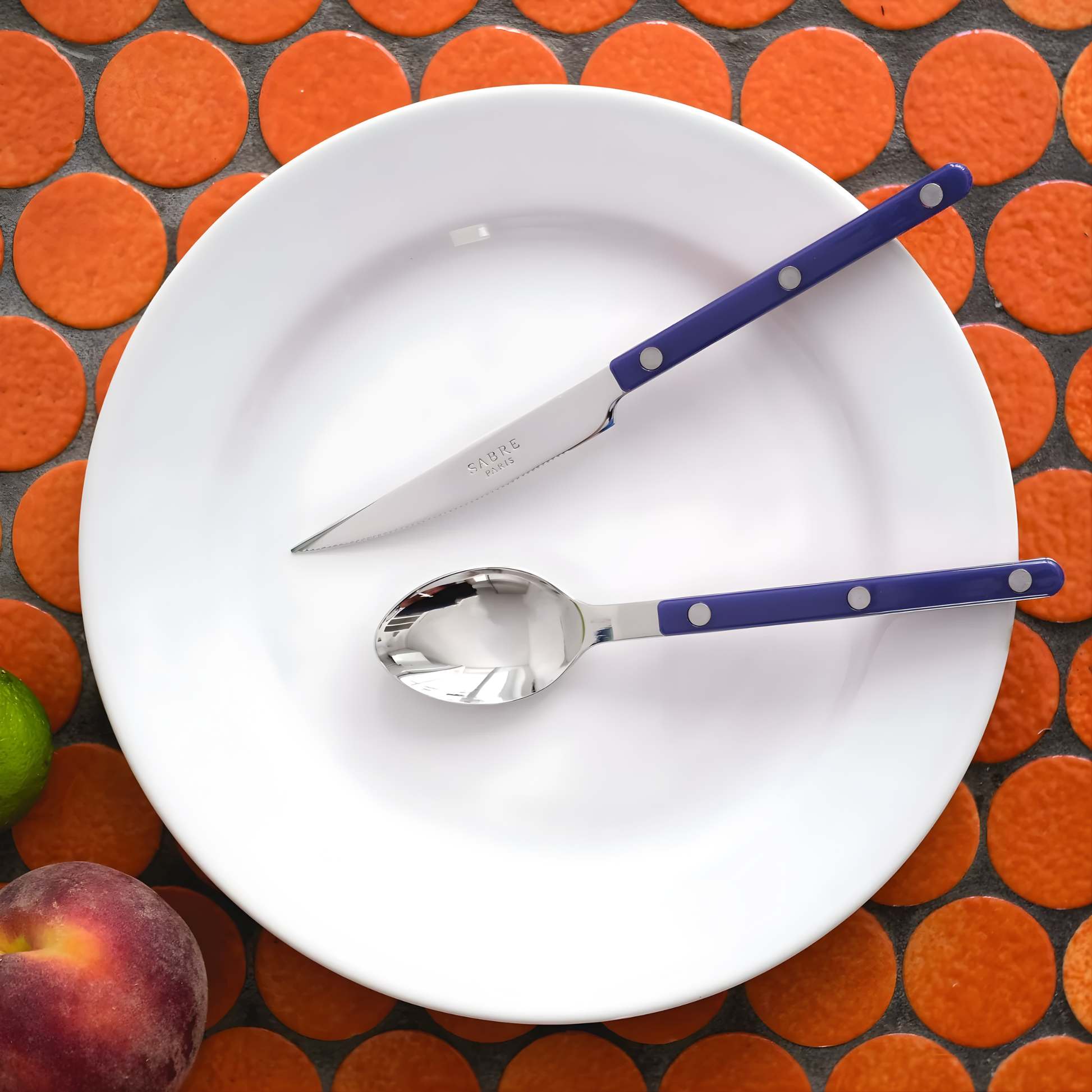 Seen on a plate the Sabre Bistrot Cutlery Spoon 22cm Navy Blue, which is made from Inox 18/10 Manche nylon designed to be both traditional and contemporary, dishwasher safe at 45 degree Celsius maximum and not suitable for microwave oven.