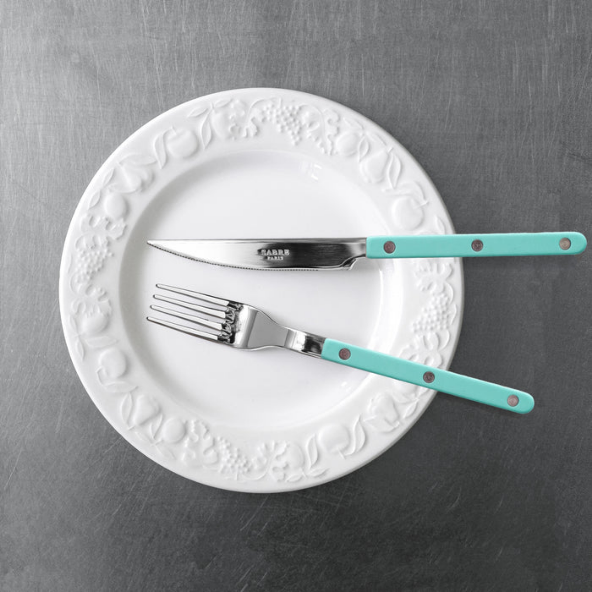 On a plate with a knife Sabre Paris Bistrot Dinner Fork 22 cm Pastel green - stainless steel and nylon café-style cutlery with visible rivets, available in gloss or vintage finish, classic yet modern fork perfect for any meal setting.