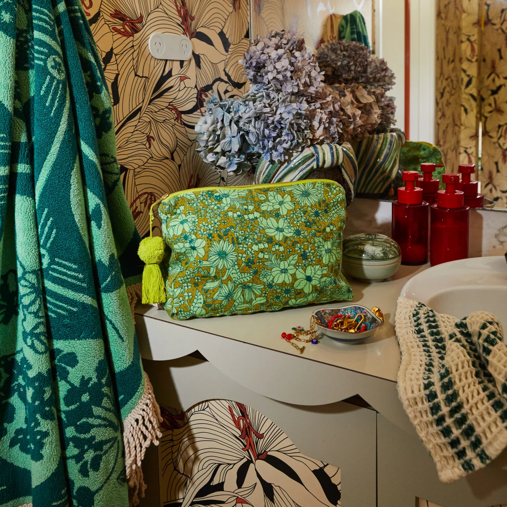 Shown in bathroom vanity setting Sage and Clare organic cotton cosmetic bag Evette with wide zip opening, tassel detail, and water-resistant lining - perfect for travel and daily essentials.