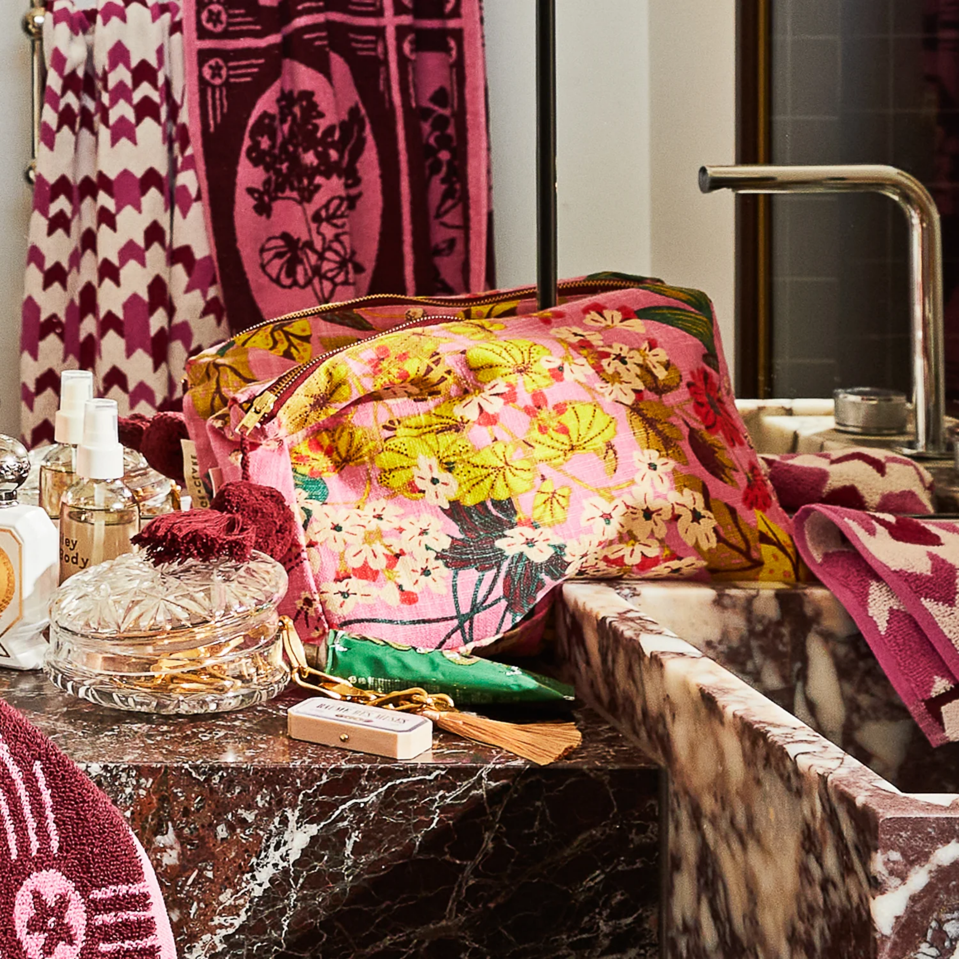 Shown in bathroom vanity setting Sage and Clare organic cotton cosmetic bag Genevieve with wide zip opening, playful tassel, and water-resistant lining. Spacious, stylish, and perfect for beauty essentials.