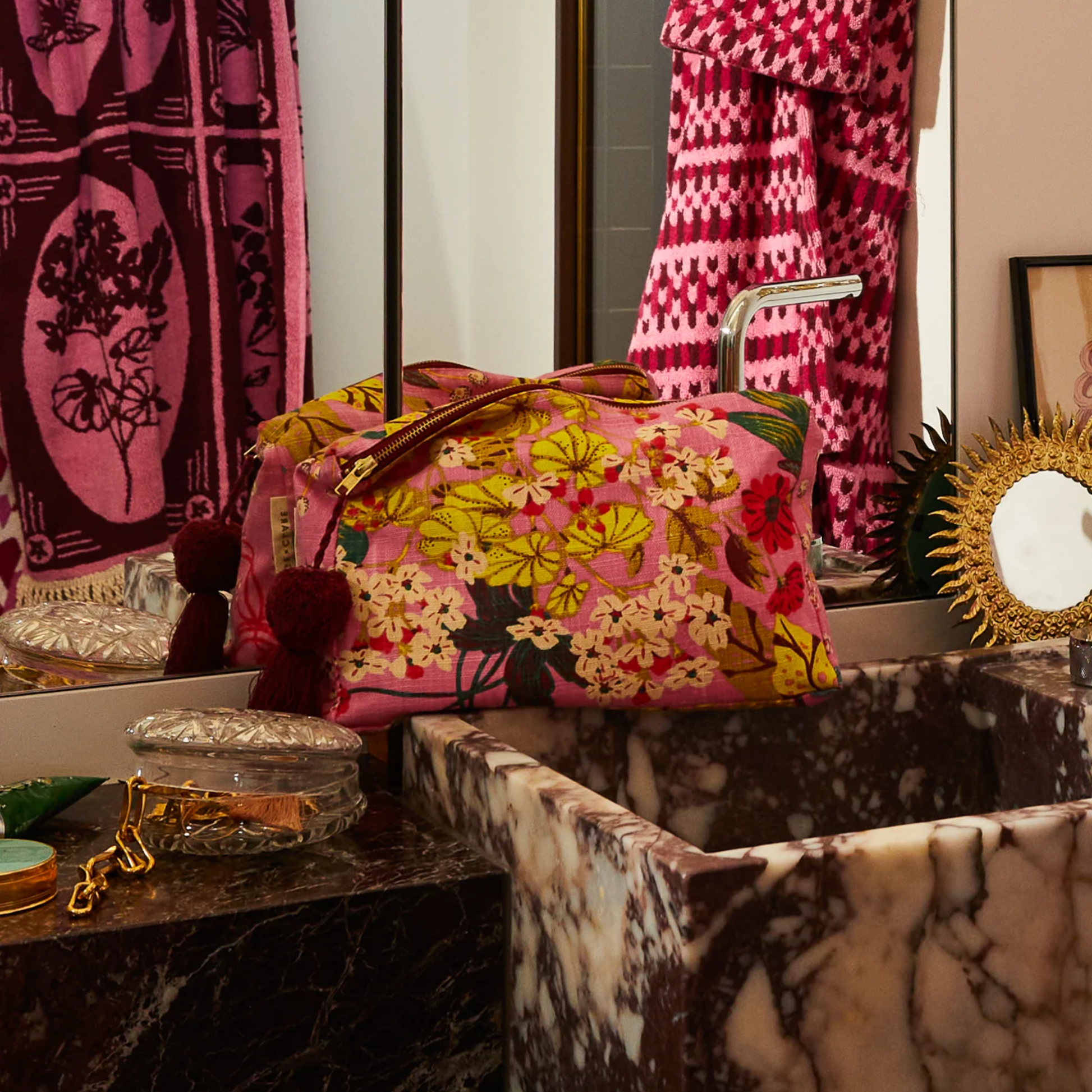 Shown in bathroom vanity setting Sage and Clare organic cotton cosmetic bag Genevieve with wide zip opening, playful tassel, and water-resistant lining. Spacious, stylish, and perfect for beauty essentials.