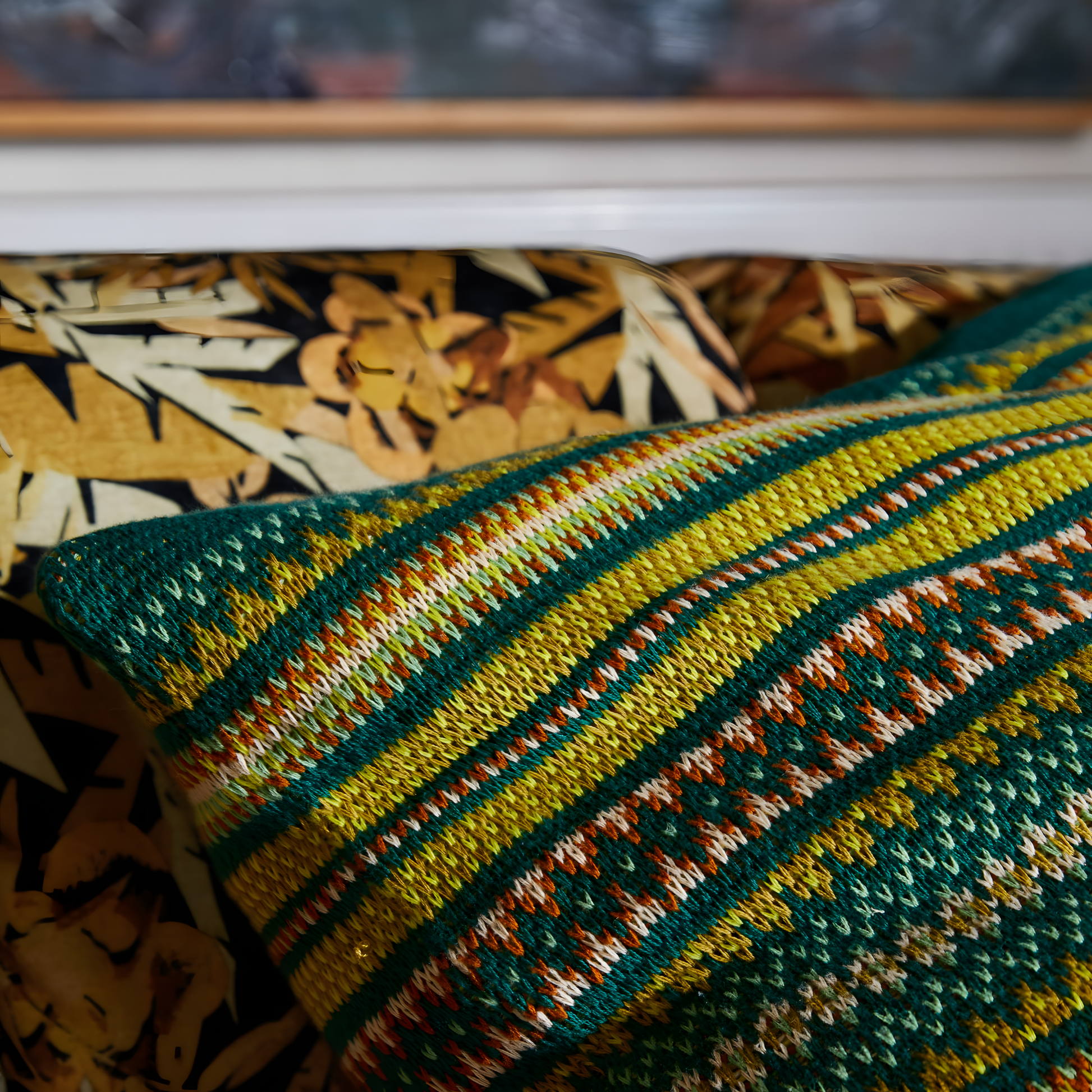 Close up view of Sage & Clare Arlette Knit Cushion in Forest, a cotton Fair Isle knitted 65×65cm decorative throw pillow with soft premium insert, textured pattern, and cozy living room or bedroom decor style.