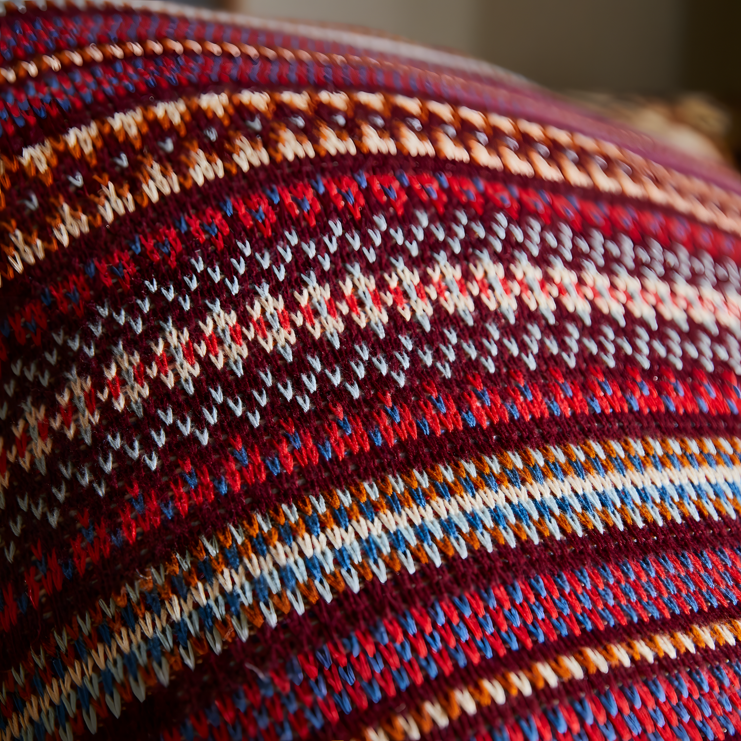 Close up view of Sage & Clare Arlette Knit Cushion in Mahogany, a 65×65cm cotton Fair Isle textured decorative throw pillow with premium soft insert.