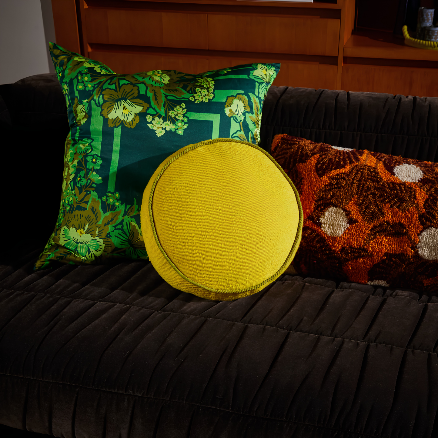 On the couch with other pillows, the Sage & Clare Cushion Dana Round Medallion made from cotton in block colours, with contrasting cord piping and high quality insert.