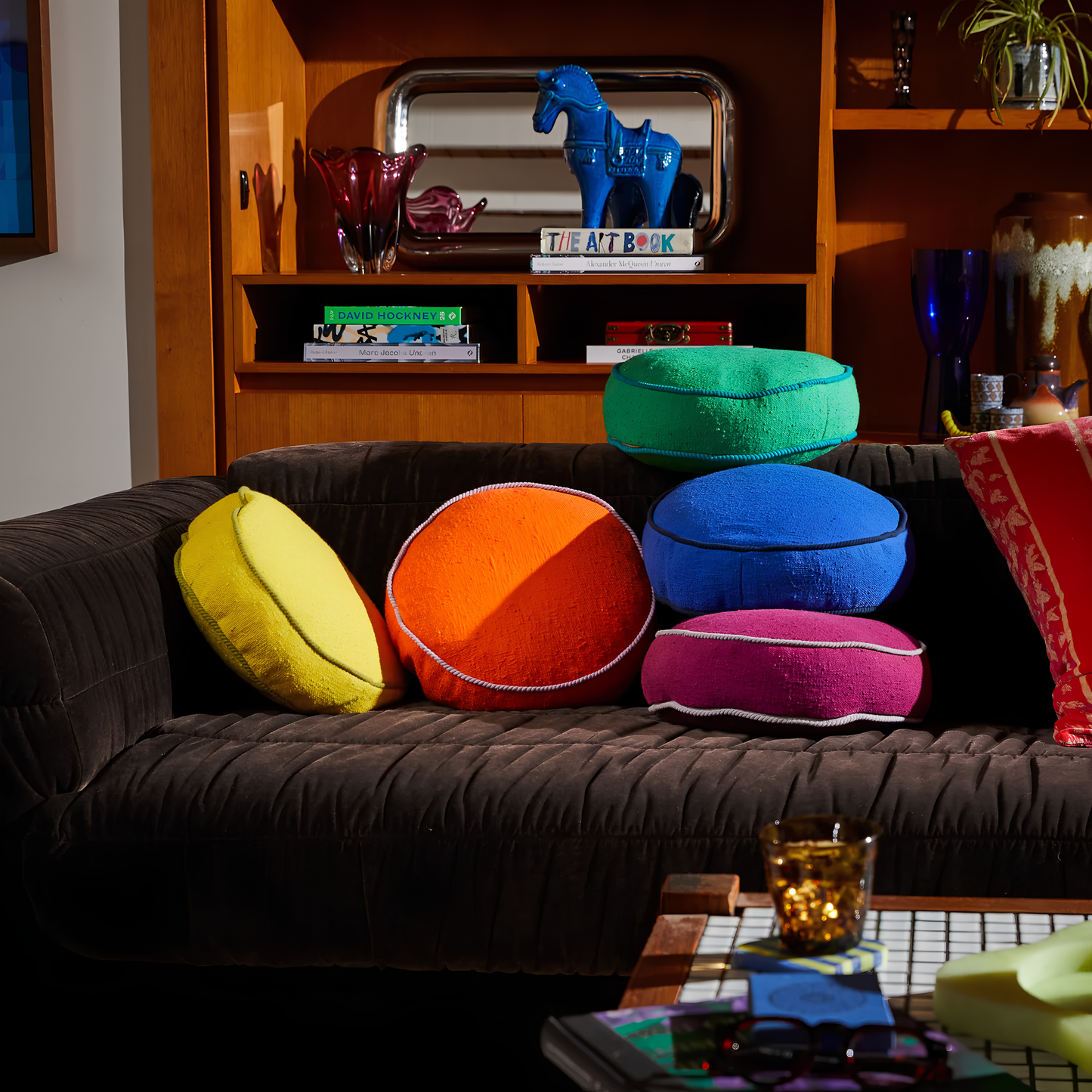 On the couch with other round pillows, the Sage & Clare Cushion Dana Round Medallion made from cotton in block colours, with contrasting cord piping and high quality insert.