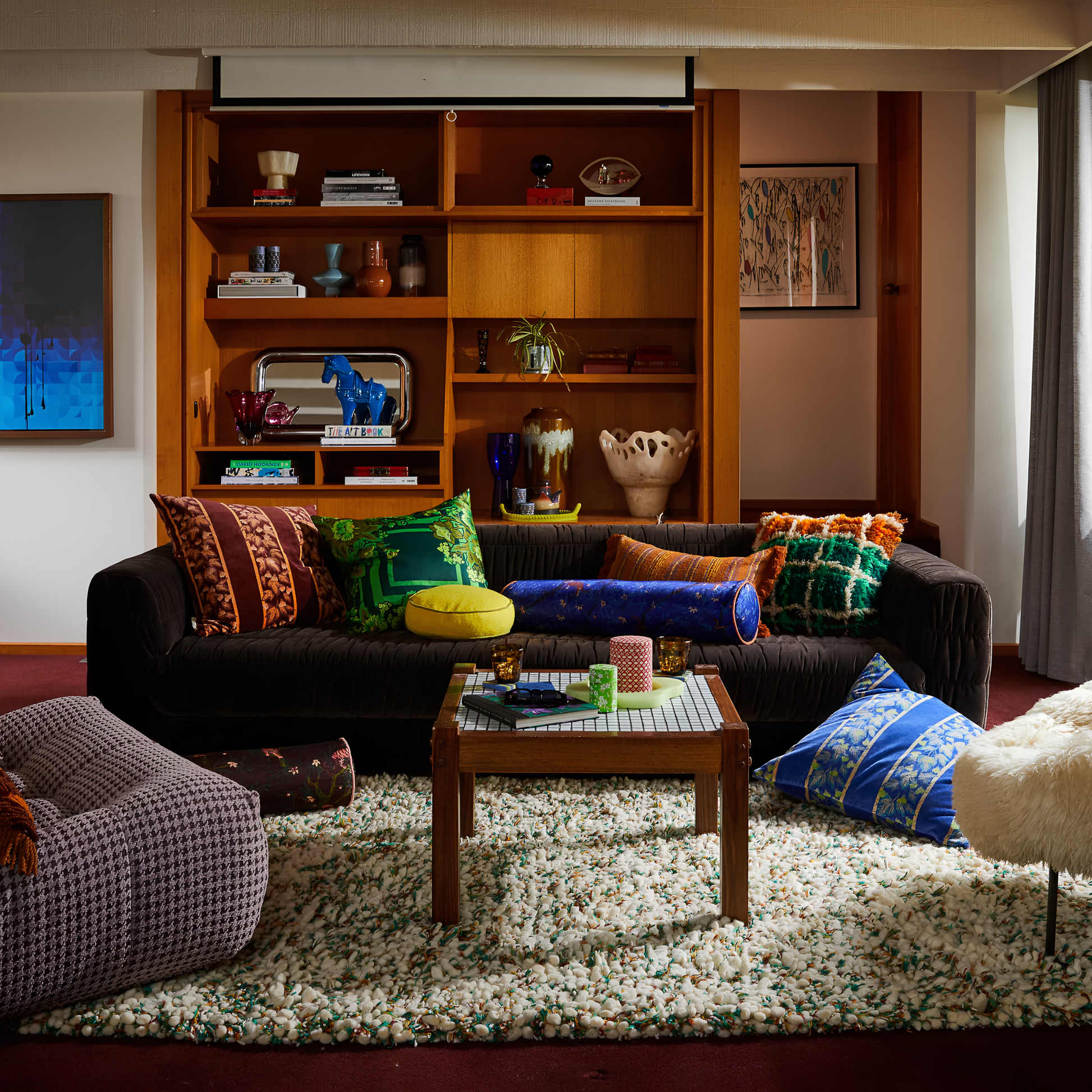 Wide angle view of the pillows on the couch with the Sage & Clare Cushion Dana Round Medallion made from cotton in block colours, with contrasting cord piping and high quality insert.