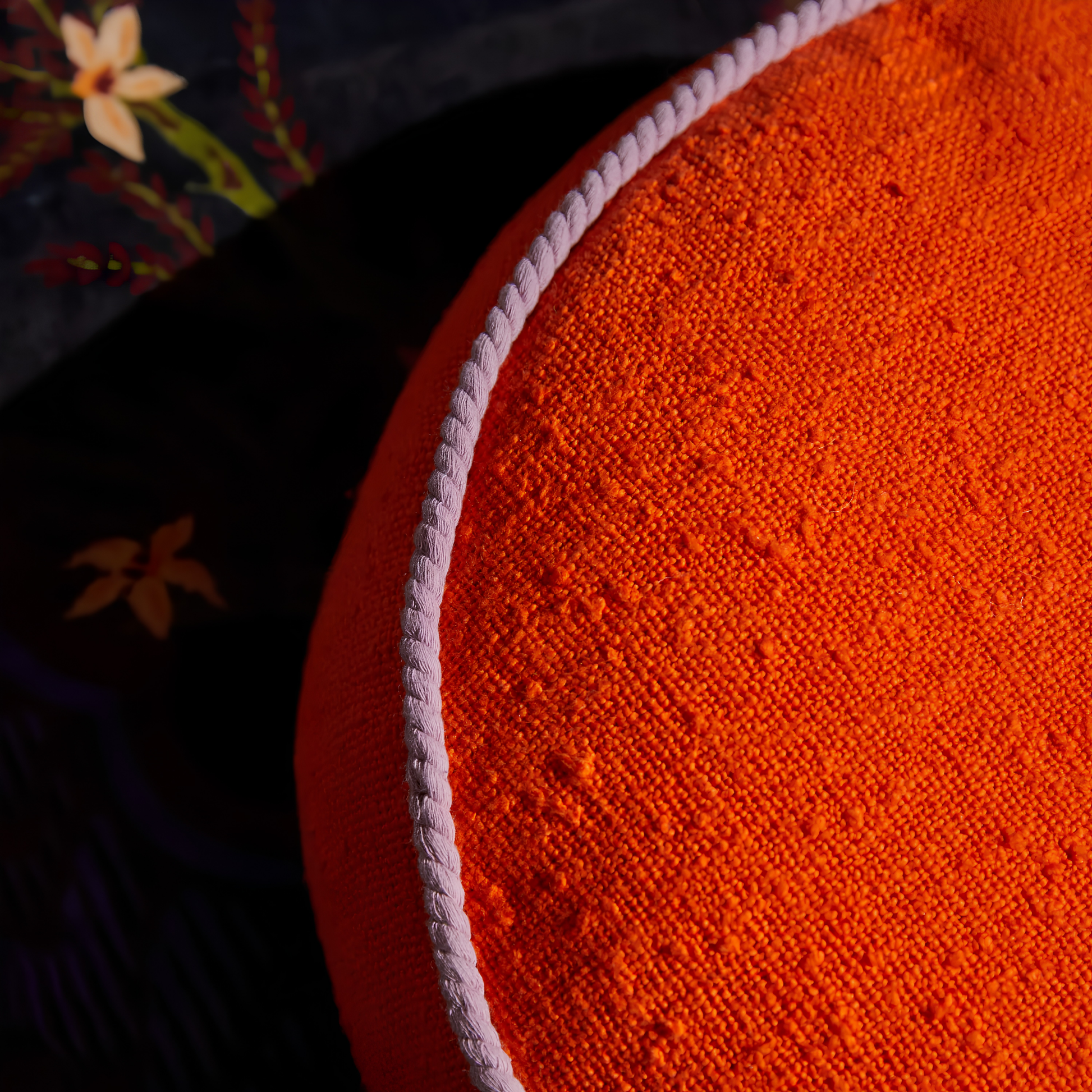 Close up on the cord piping of the Sage & Clare Cushion Dana Round Orangerie made from cotton in block colours, with contrasting cord piping and high quality insert.