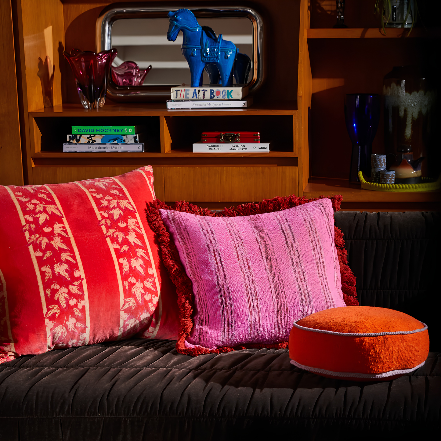 Square pillows on the couch with the Sage & Clare Cushion Dana Round Orangerie made from cotton in block colours, with contrasting cord piping and high quality insert.