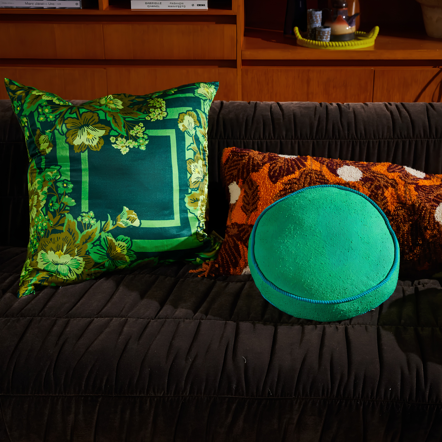 Sage & Clare Cushion Dana Round Spring Green made from cotton in block colours, with contrasting cord piping and high quality insert, seen on the couch with other pillows.