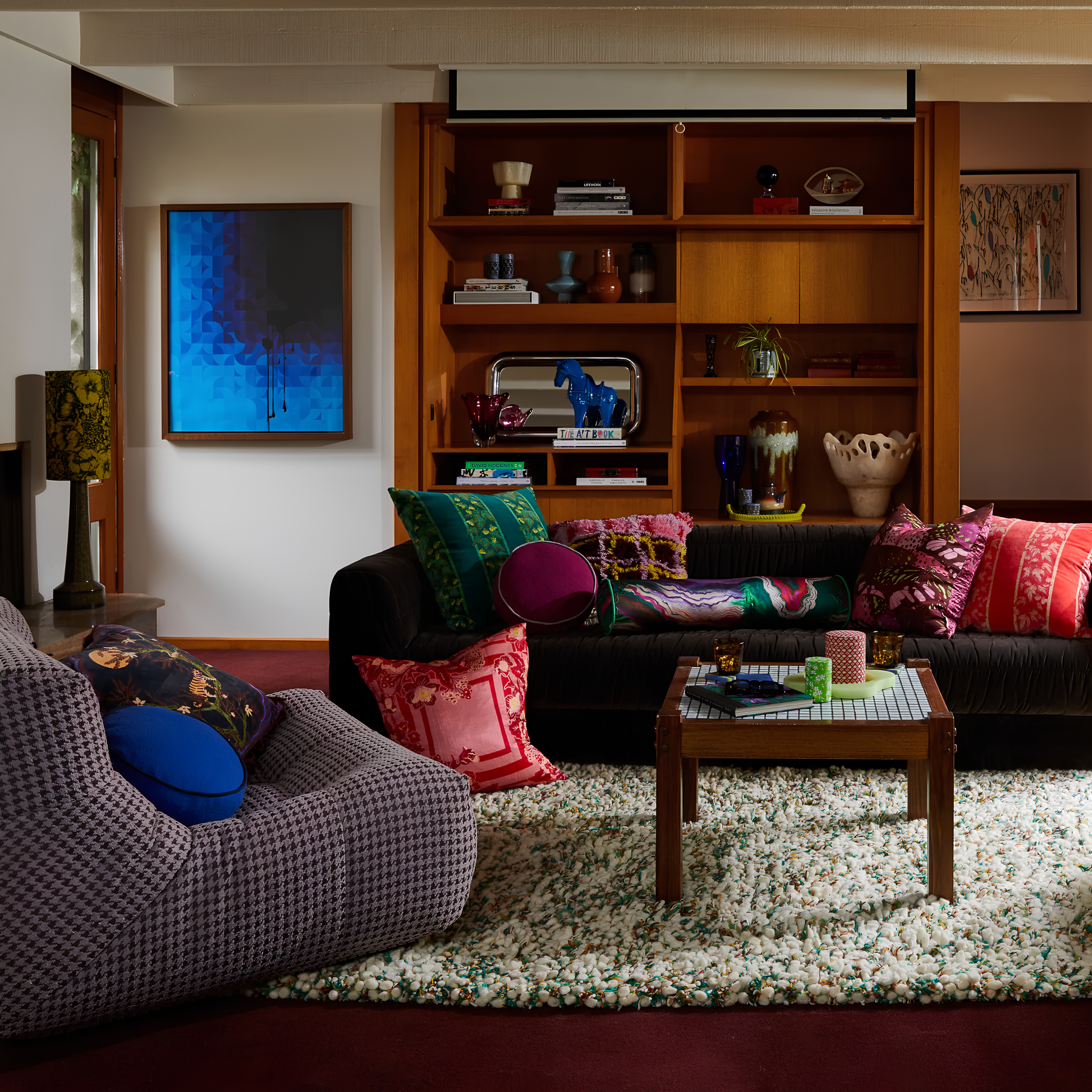 Wide angle view with the Sage & Clare Cushion Dana Round Ultramarine made from cotton in block colours, with contrasting cord piping and high quality insert, shown on the side couch.