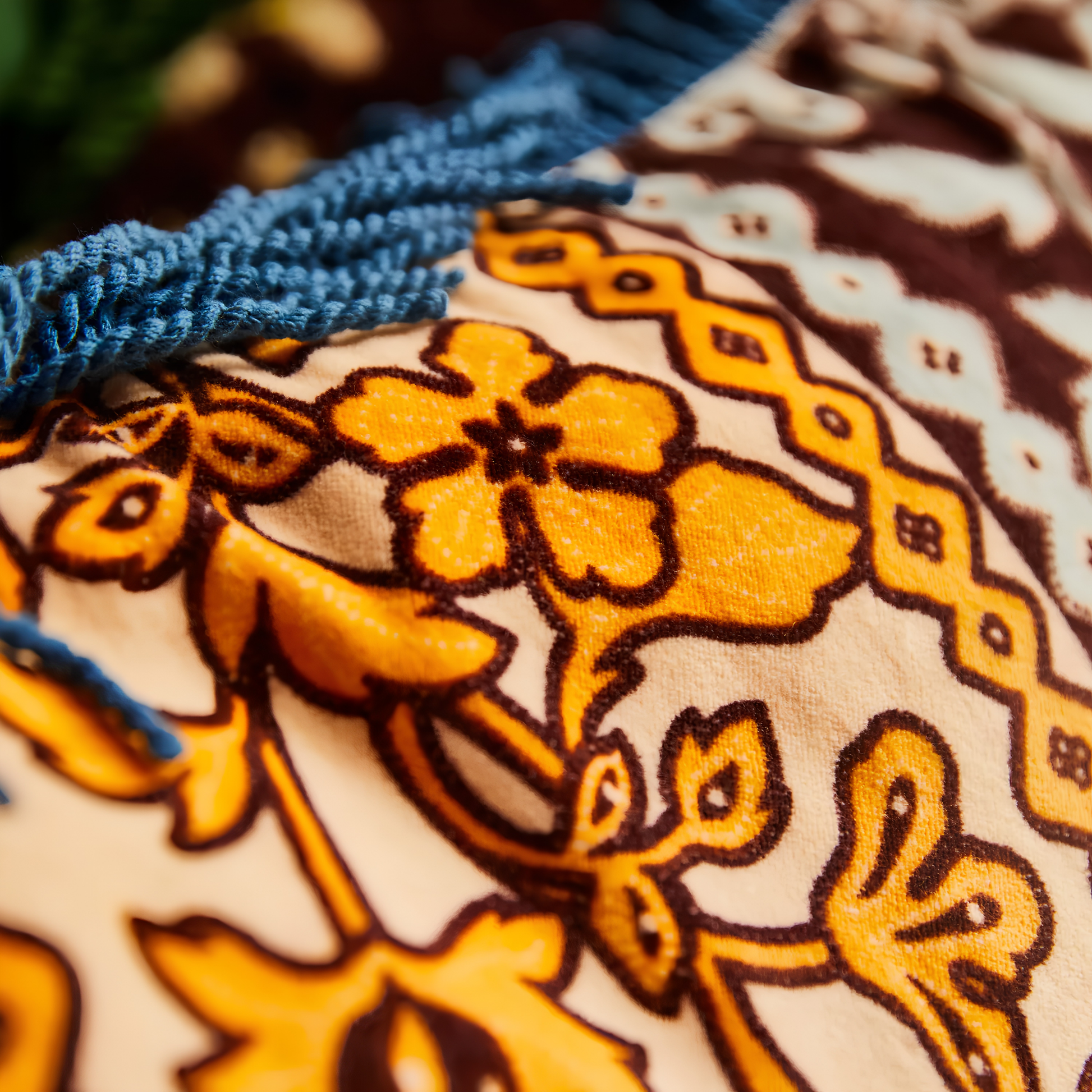 Close up view of the floral design of the Sage & Clare Cushion Thea Velvet Azure with plush texture, floral design, fringe edges and high quality insert.