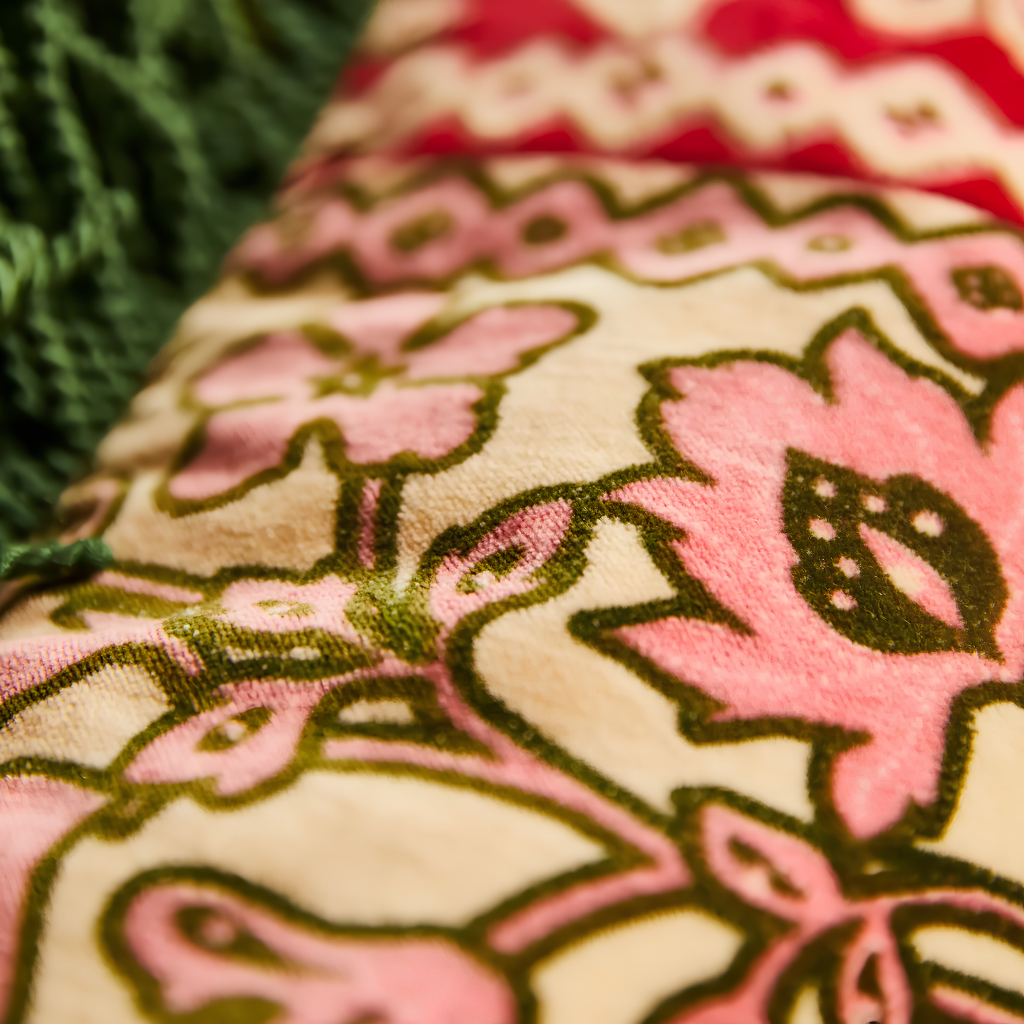 Close up on the floral design from the Sage & Clare Cushion Thea Velvet Kelp with plush texture, floral design, fringe edges and high quality insert.