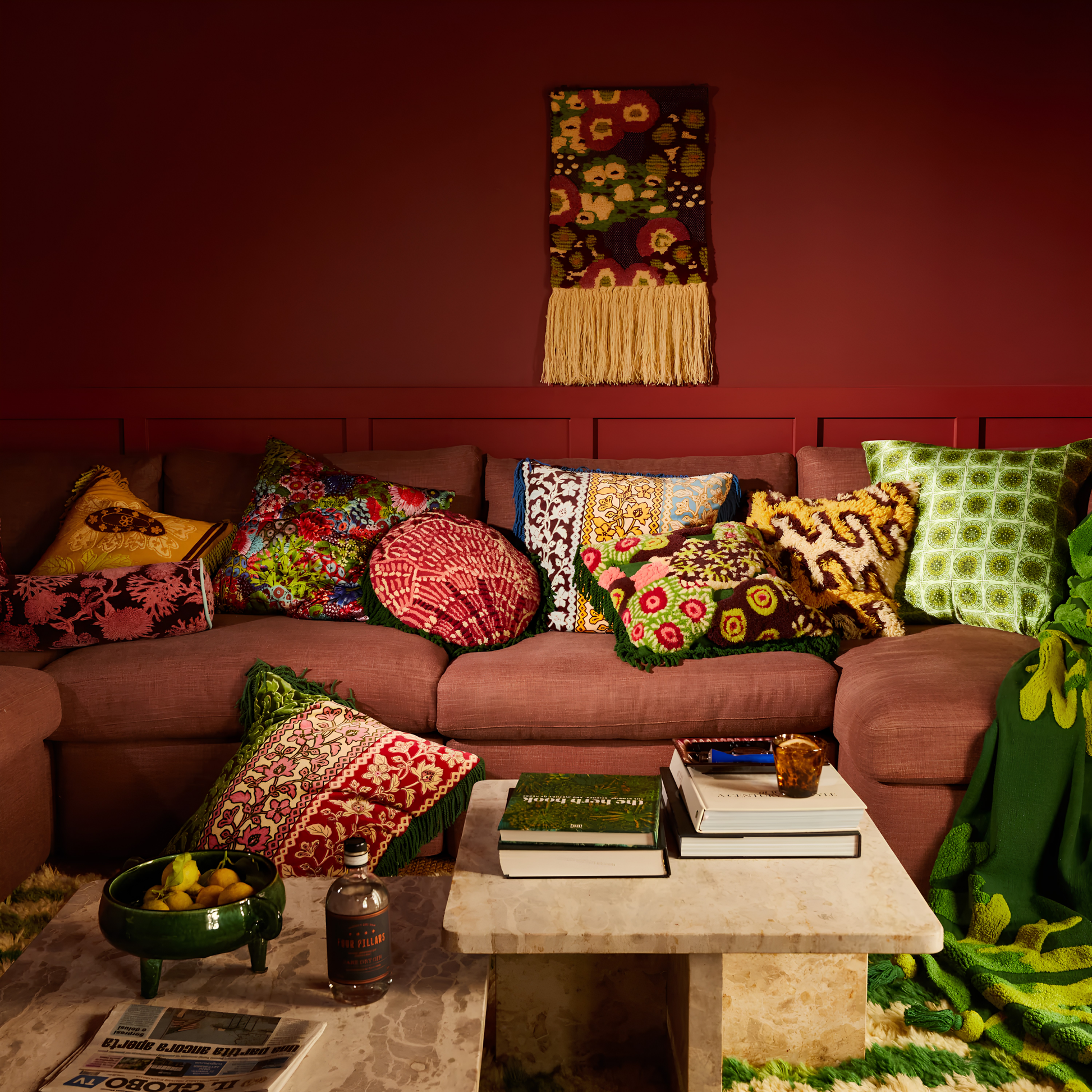 Wide view angle of the pillows with the Sage & Clare Cushion Thea Velvet Kelp with plush texture, floral design, fringe edges and high quality insert, seen beside the couch.